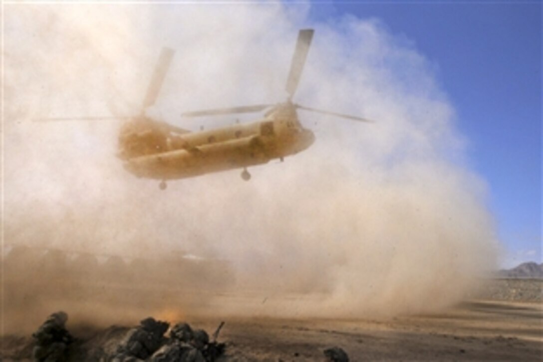 U.S. soldiers prepare to board a CH-47 Chinook troop transport helicopter after completing their mission on Forward Operating Base Muqar in Afghanistan's Ghazni province, March 14, 2014. 