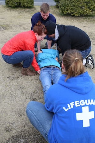 Students taking the American Red Cross’ Wilderness and Remote First Aid Course practice the proper way to transport an injured person outside of IronWorks Gym aboard Marine Corps Air Station Iwakuni, Japan, March 16, 2014. Attending the course requires cardiopulmonary resuscitation and automated external defibrillator certifications that are offered monthly by the American Red Cross aboard station.