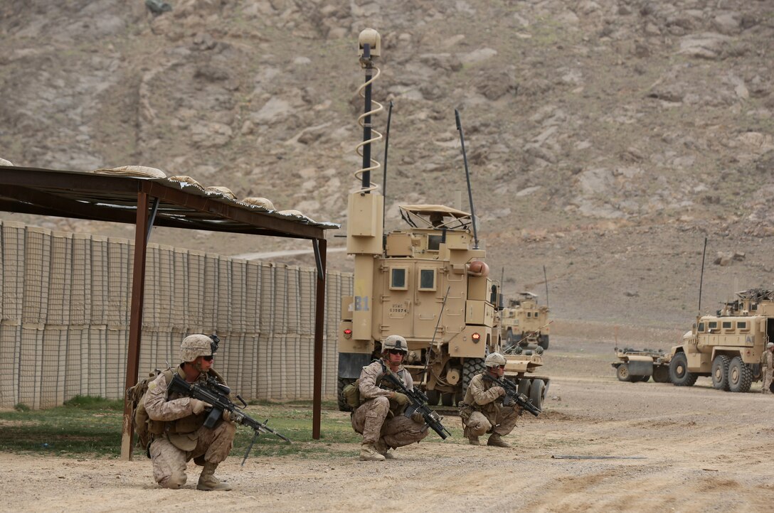 Marines with Weapons Company, 1st Battalion, 7th Marine Regiment, provide security during a Mission Rehearsal Exercise at Forward Operating Base Juno, Afghanistan, March 13, 2014. The Marines traveled to Forward Operating Base Juno 17, kilometers away, and provided security on three objectives while Afghan National Security Forces cleared the area of notional hostile threats. The MRX was a training mission to help prepare the infantrymen for potential future operations. 