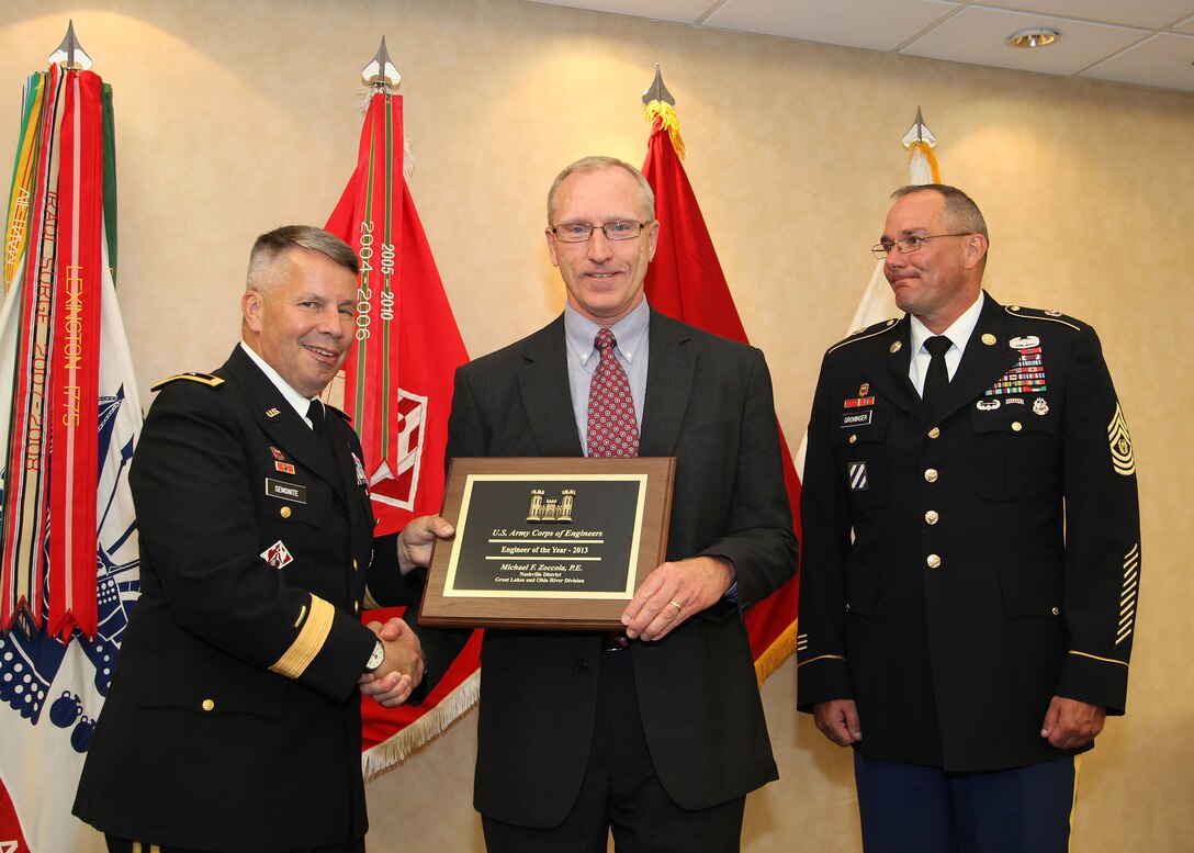 Maj. Gen. Todd T. Semonite (Left), U.S. Army Corps of Engineers deputy commander, presents the 2013 USACE Engineer of the Year Award to Mike Zoccola (Center), chief of the Nashville District Civil Design Branch, during a ceremony Aug. 5, 2013 at the Officer's Club at Ft. Belvoir, Va. USACE Command Sgt. Maj. Karl J. Groninger participated in the ceremony honoring Zoccola.