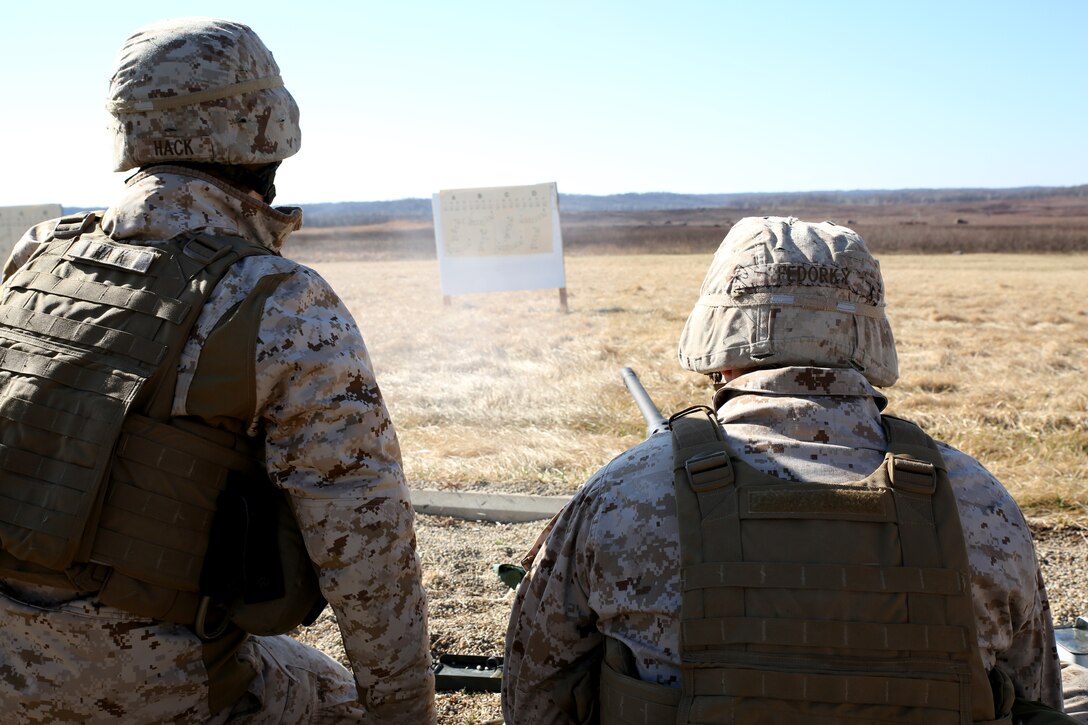 Camp Atterbury, Ind. - Lance Cpl’s. Andrew Hack (Left) and Cory Fedorky fire an M2 Heavy Barrel .50 caliber machine gun during a 25-meter sighting-range target shoot, as part of their Reserve forces drill period training, March 15, 2014, at a firing range on Camp Atterbury Joint Maneuver Center. Hack and Fedorky are machine gunners with Weapons Company, 2nd Battalion, 24th Marine Regiment, 4th Marine Division. (Marine Corps photo by Cpl. J. Gage Karwick/released)