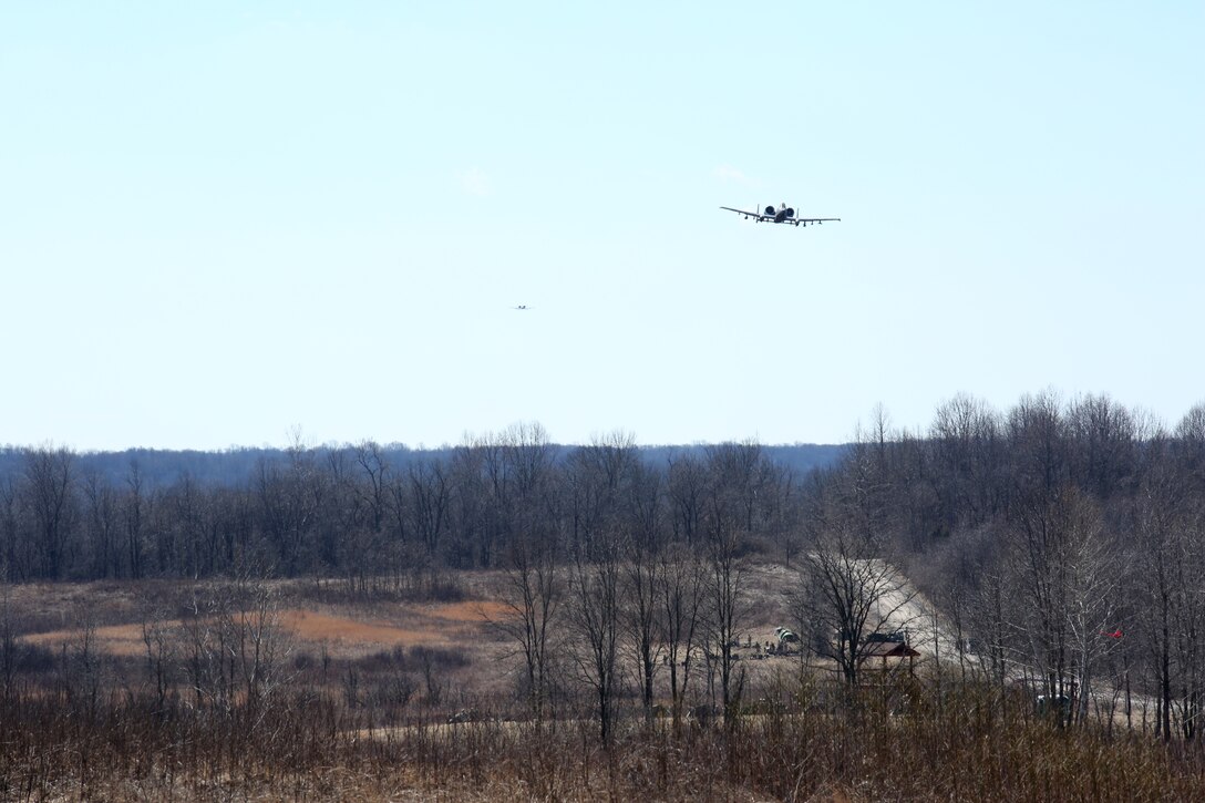 Camp Atterbury, Ind. – Two A-10 Thunderbolt II’s fly low to the ground after being called in for a fire-support mission by joint terminal attack control Marines on the ground, March 15, 2014, at a firing range on Camp Atterbury Joint Maneuver Center. The A-10s were on station to assist the Marines in live combined-arms training in addition to supporting their own training requirements. The Marine Corps worked alongside the Ind. Air National Guard to make this training possible, allowing both parties to see the true effects of their missions. The A-10s are with the 163rd Fighter Squadron, 122nd Fighter Wing located at Fort Wayne Air National Guard Station, Ind. The Marines are with 2nd Battalion, 24th Marine Regiment, 4th Marine Division. (Marine Corps photo by Cpl. J. Gage Karwick/released)