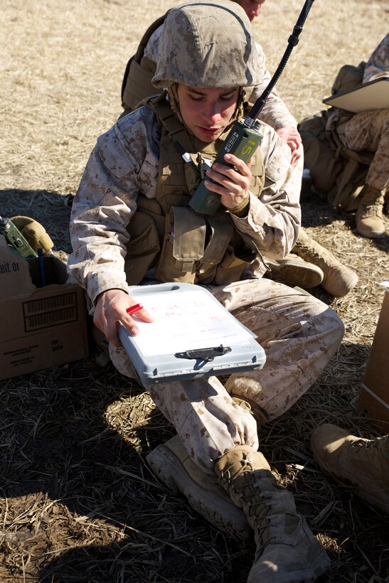 Camp Atterbury, Ind. - Pfc. Robert Perez, a field radio operator with Weapons Company, 2nd Battalion, 24th Marine Regiment, 4th Marine Division, double checks coordinates in a call-for-fire mission directed toward a mortar platoon as part of their Reserve forces drill period training, March 15, 2014, at a firing range on Camp Atterbury Joint Maneuver Center. After receiving the coordinates, Perez relayed the information to fire direction center Marines to locate the target. Then the FDC Marines shouted out the target coordinates to the mortar teams. (Marine Corps photo by Cpl. J. Gage Karwick/released)