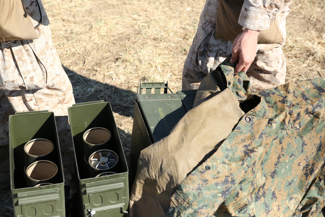 Camp Atterbury, Ind. Marines cover their ready mortar rounds with a tarp to protect them from water and debris during their Reserve forces drill period training, March 15, 2014, at a firing range on Camp Atterbury Joint Maneuver Center. The Marines are with Weapons Company, 2nd Battalion, 24th Marine Regiment, 4th Marine Division. (Marine Corps photo by Cpl. J. Gage Karwick/released)