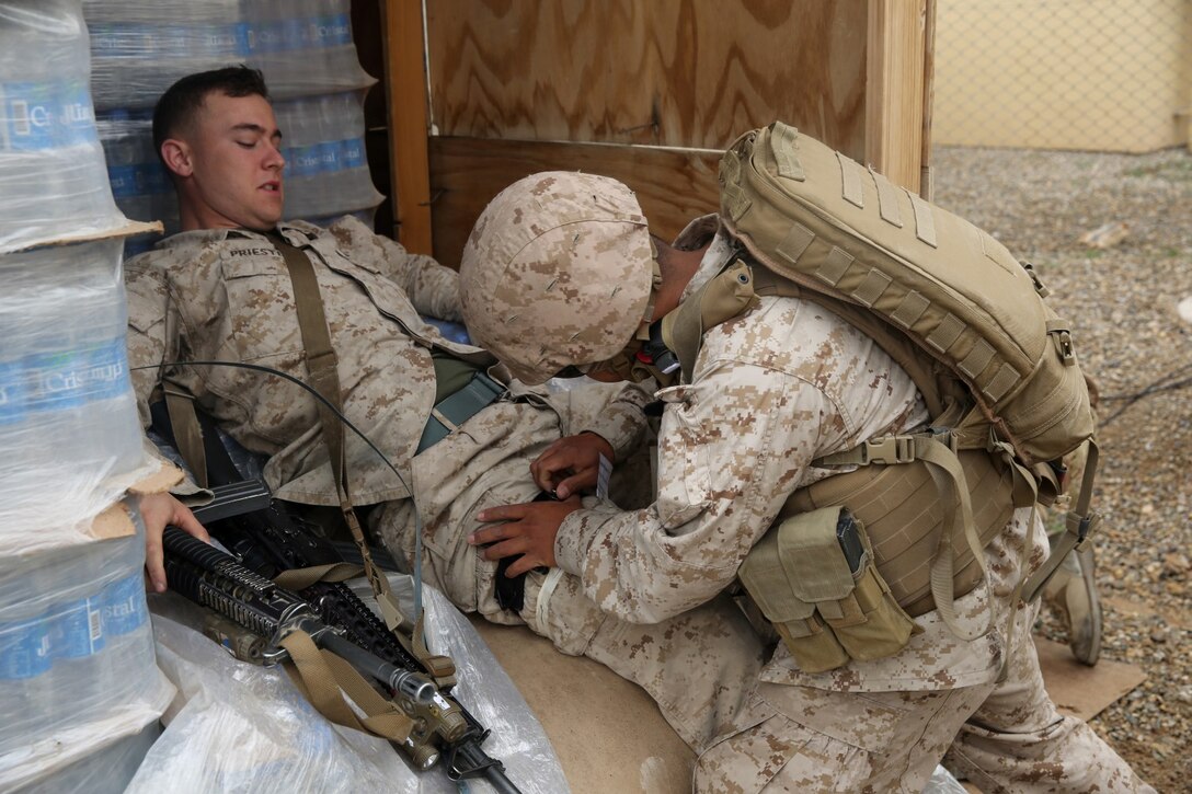 Seaman John Santos, corpsman, Headquarters and Service Company, 1st Battalion, 7th Marine Regiment, and a native of the Phillipines, applies a tourniquet to a simulated casualty during a training drill aboard Camp Leatherneck, Afghanistan, March 14, 2014. The drill was designed to ensure accountability of all personnel and gear while practicing movement to muster locations in the event of an emergency. The battalion had Navy corpsmen with 3rd Battalion, 7th Marine Regiment, evaluate the service members as they reacted to the situation. “I think it was vital to establish a baseline of our reactions,” said Petty Officer 1st Class Jeson Hall, a corpsman with 1st Bn., 7th Marines, and a native of Florence, Ala. “Establishing a baseline give us measures for success so we can continue to improve during future drills.” (U.S. Marine Corps photo by Cpl. Joseph Scanlan)