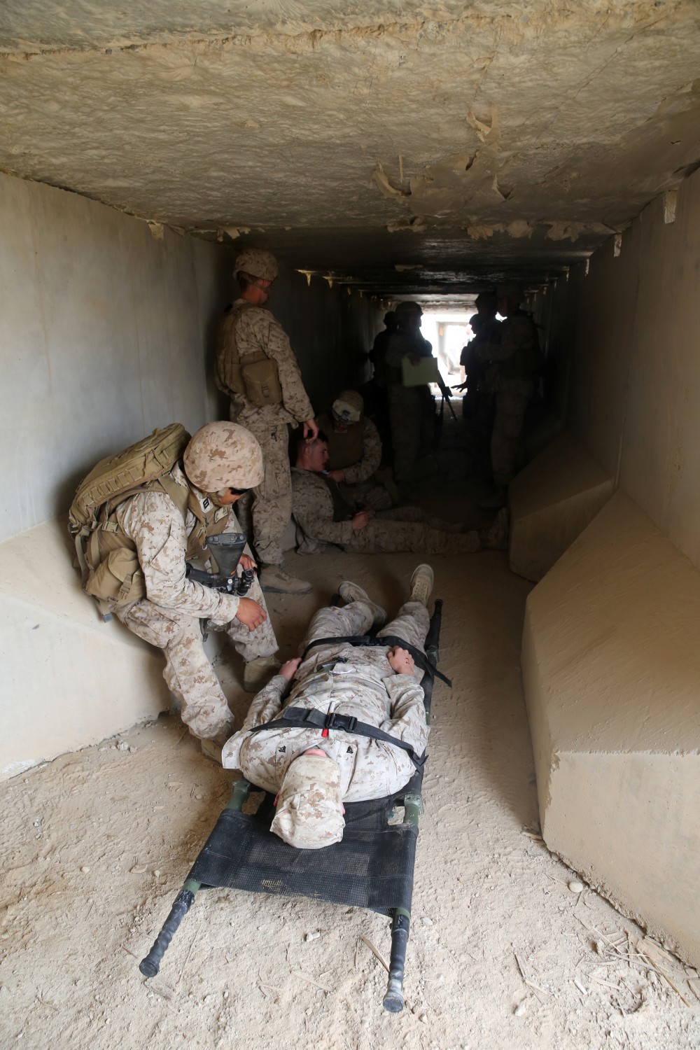 Navy corpsmen with Headquarters and Service Company, 1st Battalion, 7th Marine Regiment, treat simulated casualties at a muster point during a training drill aboard Camp Leatherneck, Afghanistan, March 14, 2014. The drill was designed to ensure accountability of all personnel and gear while practicing movement to muster locations in the event of an emergency. The battalion had Navy corpsmen with 3rd Battalion, 7th Marine Regiment, evaluate the service members as they reacted to the situation. “I think it was vital to establish a baseline of our reactions,” said Petty Officer 1st Class Jeson Hall, a corpsman with 1st Bn., 7th Marines, and a native of Florence, Ala. “Establishing a baseline give us measures for success so we can continue to improve during future drills.” (U.S. Marine Corps photo by Cpl. Joseph Scanlan)