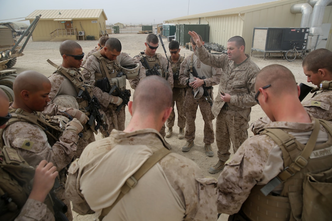 Navy Lt. Andrew Brod, chaplain, 1st Battalion, 7th Marine Regiment, says a prayer before Marines with Weapons Company conduct a partnered Mission Rehearsal Exercise at Forward Operating Base Juno, Afghanistan, March 13, 2014. The Marines traveled to Forward Operating Base Juno, 17 kilometers away, and provided security on three objectives while Afghan National Security Forces cleared the area of notional hostile threats. The MRX was a training mission to help prepare the infantrymen for potential future operations. 