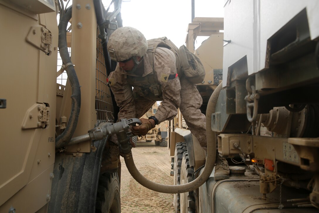 Corporal Jesus Garza, fuel truck operator, Headquarters and Support Company, 1st Battalion, 7th Marine Regiment, and a native of McAllen, Texas, refuels a Mine Resistant Ambush Protected Vehicle during a Mission Rehearsal Exercise at Forward Operating Base Juno, Afghanistan, March 13, 2014. The Marines traveled to Forward Operating Base Juno, 17 kilometers away, and provided security on three objectives while Afghan National Security Forces cleared the area of notional hostile threats. The MRX was a training mission to help prepare the infantrymen for potential future operations. 