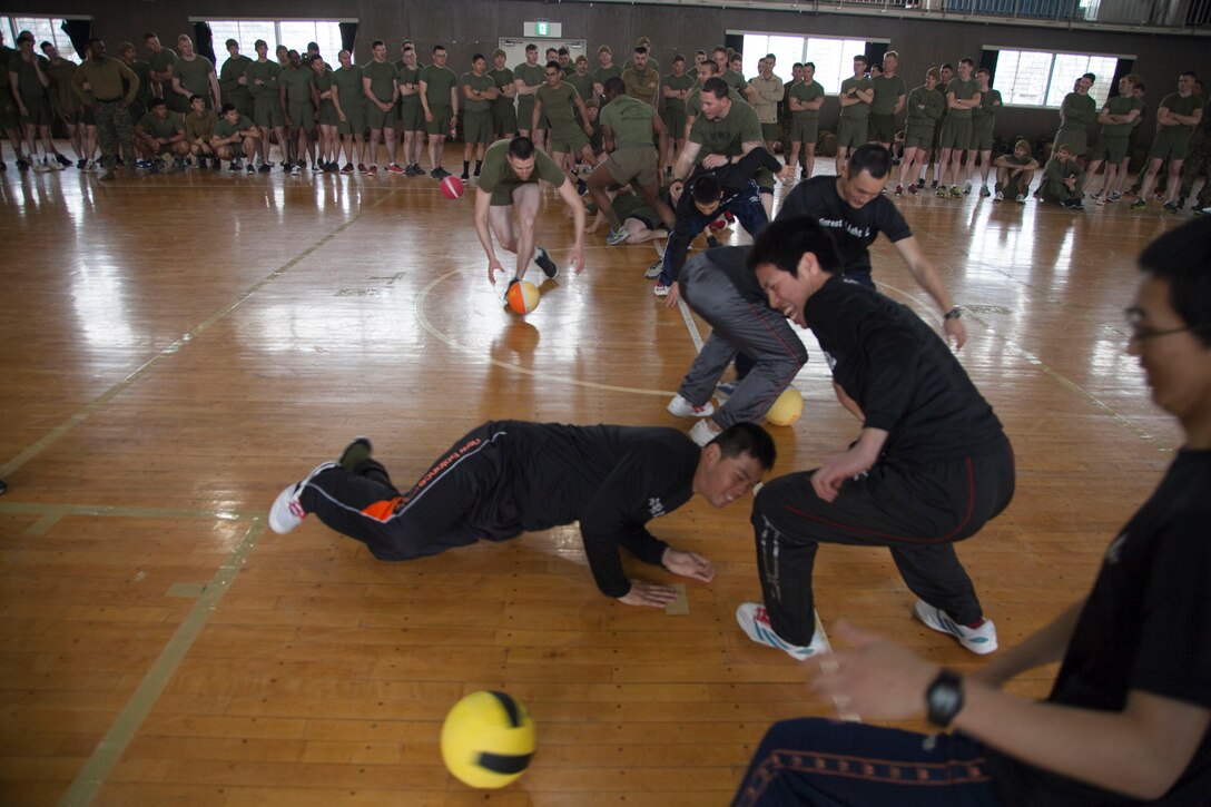 Japan Ground Self-Defense Force members and U.S. Marines rush to retrieve dodgeballs at the beginning of a match during the culture day for Exercise Forest Light 14-2 March 3 at Camp Takada, Niigata prefecture, Japan. The dodgeball tournament allowed the two forces to get to know each other in a more personal way. The JGSDF members are with 2nd Infantry Regiment, 12th Brigade, Eastern Army. The Marines are with Company I, 3rd Battalion, 1st Marine Regiment, currently assigned to 4th Marines, 3rd Marine Division, III Marine Expeditionary Force, under the unit deployment program. (U.S. Marine Corps photo by Lance Cpl. Joey S. Holeman Jr./Released)