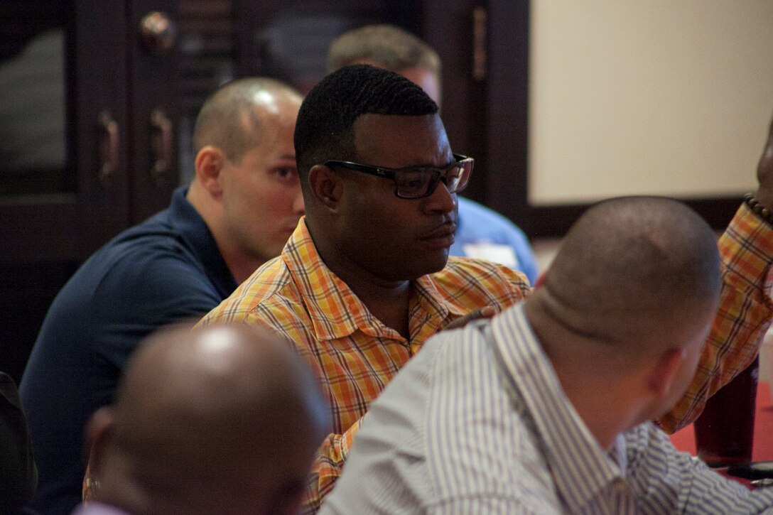 Gunnery Sgt. Kenge D. Herron participates in a discussion during an Equal Opportunities Representatives Course at the Ocean Breeze on Camp Foster March 4. The class was open to civilians, officers and staff noncommissioned officers interested in becoming EO representatives. Herron is a logistics chief with Marine Air Support Squadron 2, Marine Air Control Group 18, 1st Marine Aircraft Wing, III Marine Expeditionary Force. (U.S. Marine Corps photo by Lance Cpl. Pete Sanders/Released)


