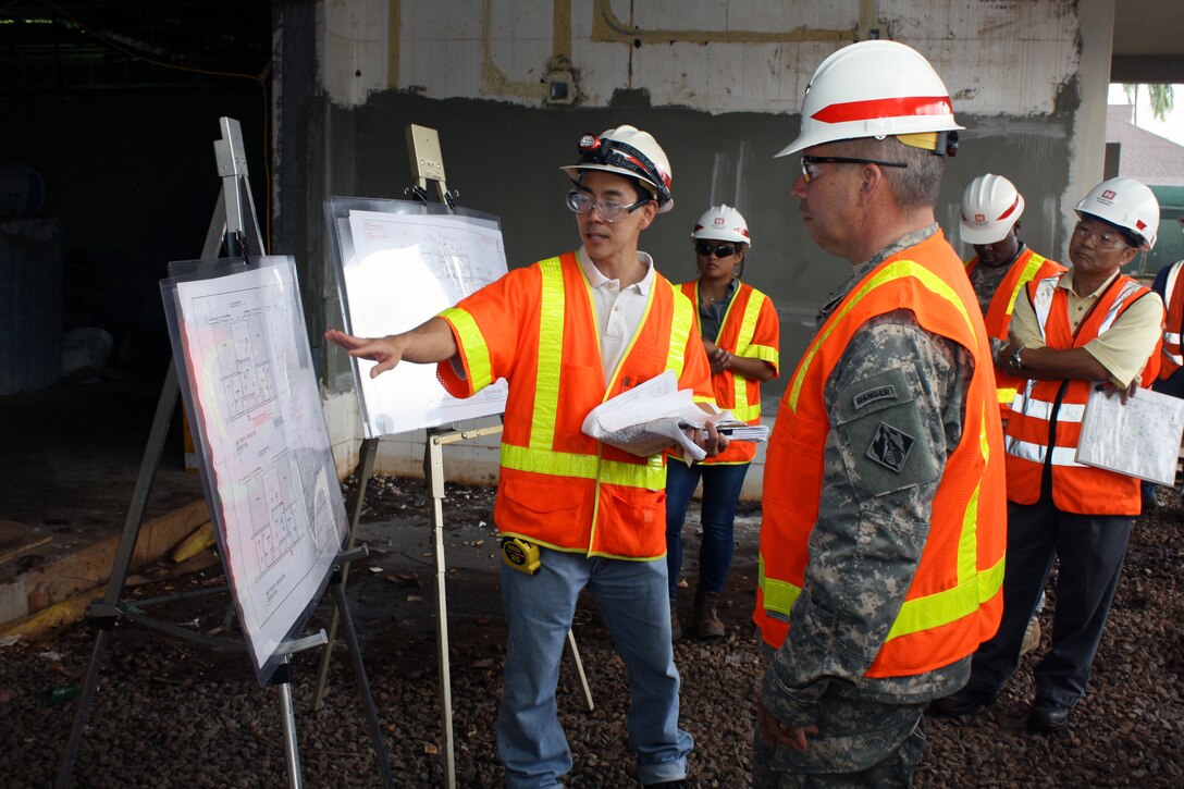 Maj. Gen. Todd T. Semonite, U.S. Army Corps of Engineers Deputy Commander and Deputy Chief of Engineers (center right), listens as Warriors in Transition (WIT) project manager Mike Onuma explains the different floorplans for the barracks section of the project.Listening at right is Schofield Barracks Area Office Resident  Engineer Jason Tanaka.  