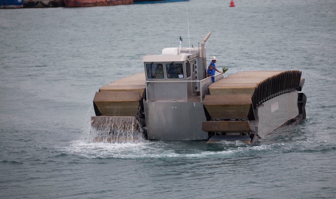 Members of Navatek Ltd., a ship-building company, prepare the Ultra Heavy-lift Amphibious Connector (UHAC) to begin its first-ever test run in Honolulu Harbor here, March 3. The Marine Corps Warfighting Lab came here to observe the UHAC's capabilities in land and water.