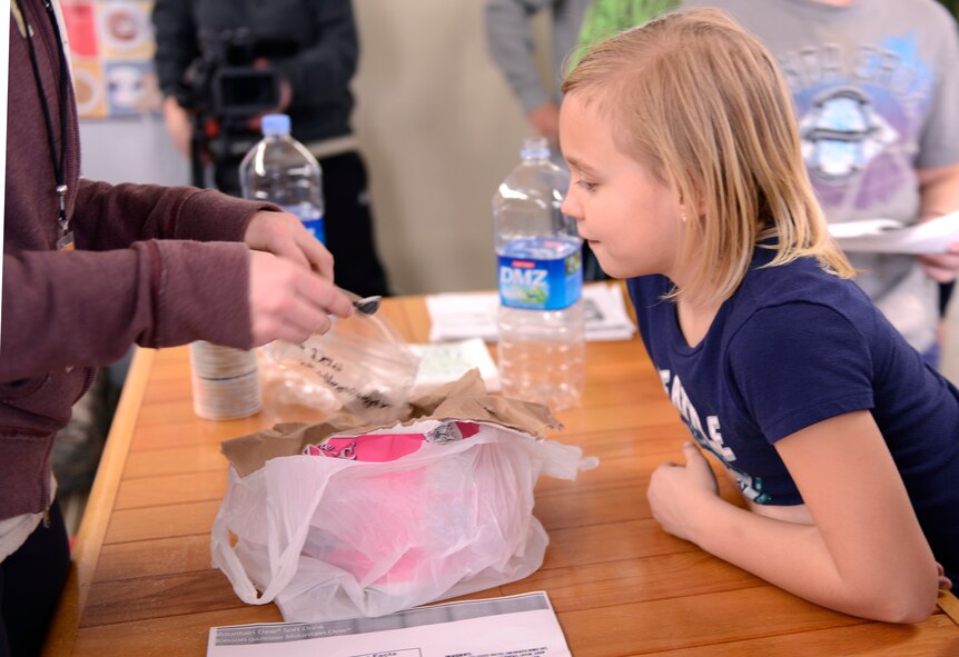 Children learn how to read the nutritional facts and view first-hand how much sugar is in some of their favorite drinks to help them make smarter drink decisions while participating in the Healthy Habits Program at the Youth Center at Osan Air Base, Republic of Korea, March 19, 2014. The Healthy Habits Program was a five-week course offered by the 51st Medical Group with the assistance of base volunteers to teach children about making healthy decisions. (U.S. Air Force photo/Tech. Sgt. Micky M. Bazaldua)