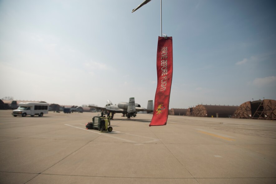 A "remove before flight" tag hangs off the wing of an A-10 March 17, 2014, at Osan Air Base, Republic of Korea. The mission of Osan is to preserve stability on the peninsula of Korea through constant readiness. (U.S Air Force photo by Staff Sgt. Jake Barreiro)