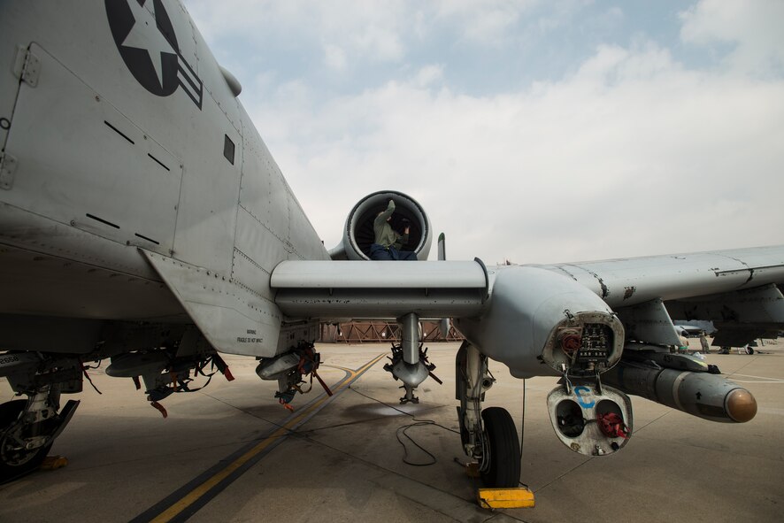 Senior Airman Kevin Lacy, a 25th Fighter Squadron crew chief, works on an A-10 March 17, 2014, at Osan Air Base, Republic of Korea. Osan Air Base's primary mission is to preserve stability on the Peninsula of Korea through constant readiness. (U.S. Air Force photo by Staff Sgt. Jake Barreiro)
