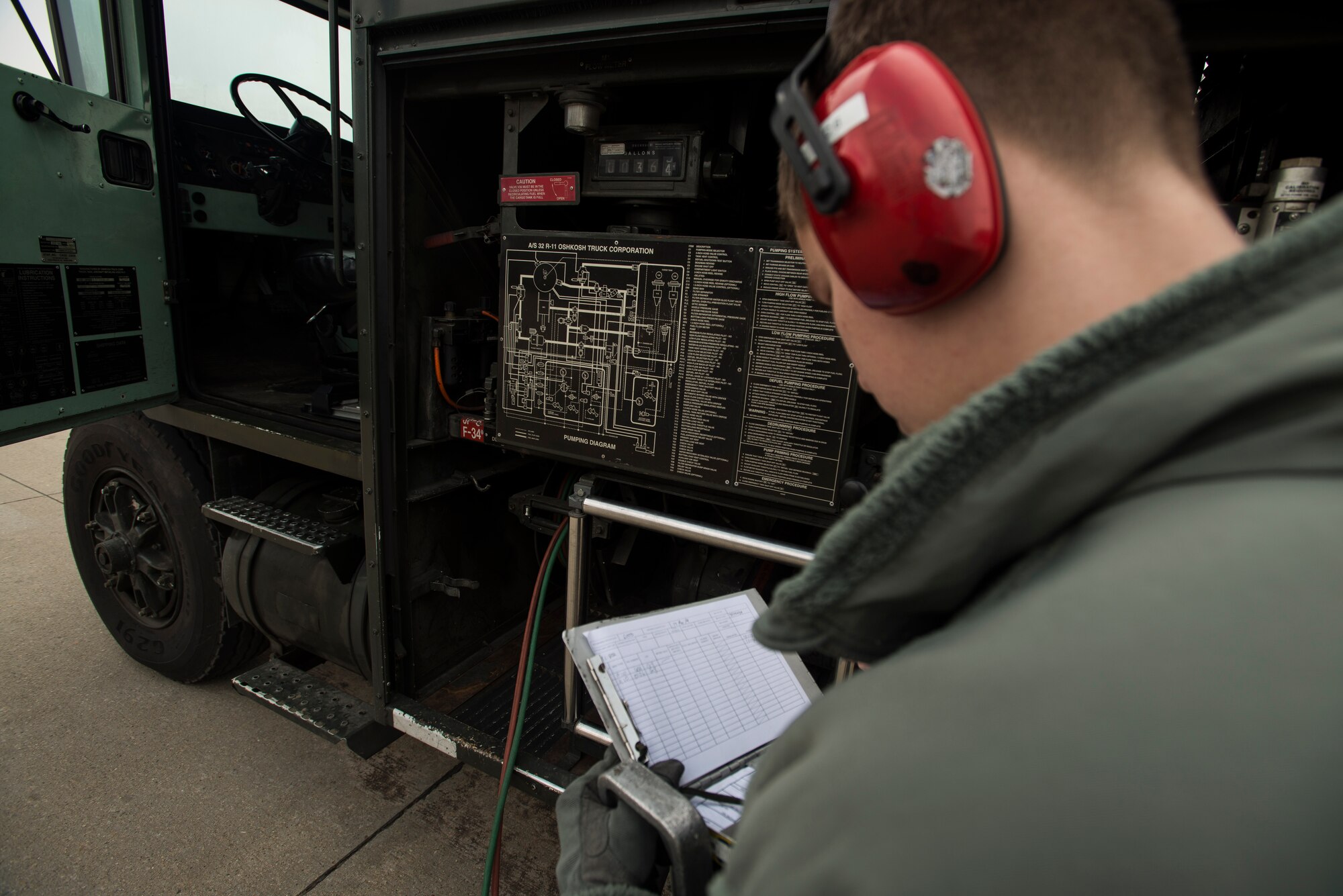 Airman 1st Class Robert Youngs, a 51st Logistic Readiness Squadron fuels operator, annotates the progress of a refueling March 18, 2014, at Osan Air Base, Republic of Korea. Fuel operators like Youngs refuel multiple aircraft everyday, ensuring the planes of Osan standby to preserve stability on the peninsula. (U.S. Air Force photo by Staff Sgt. Jake Barreiro)