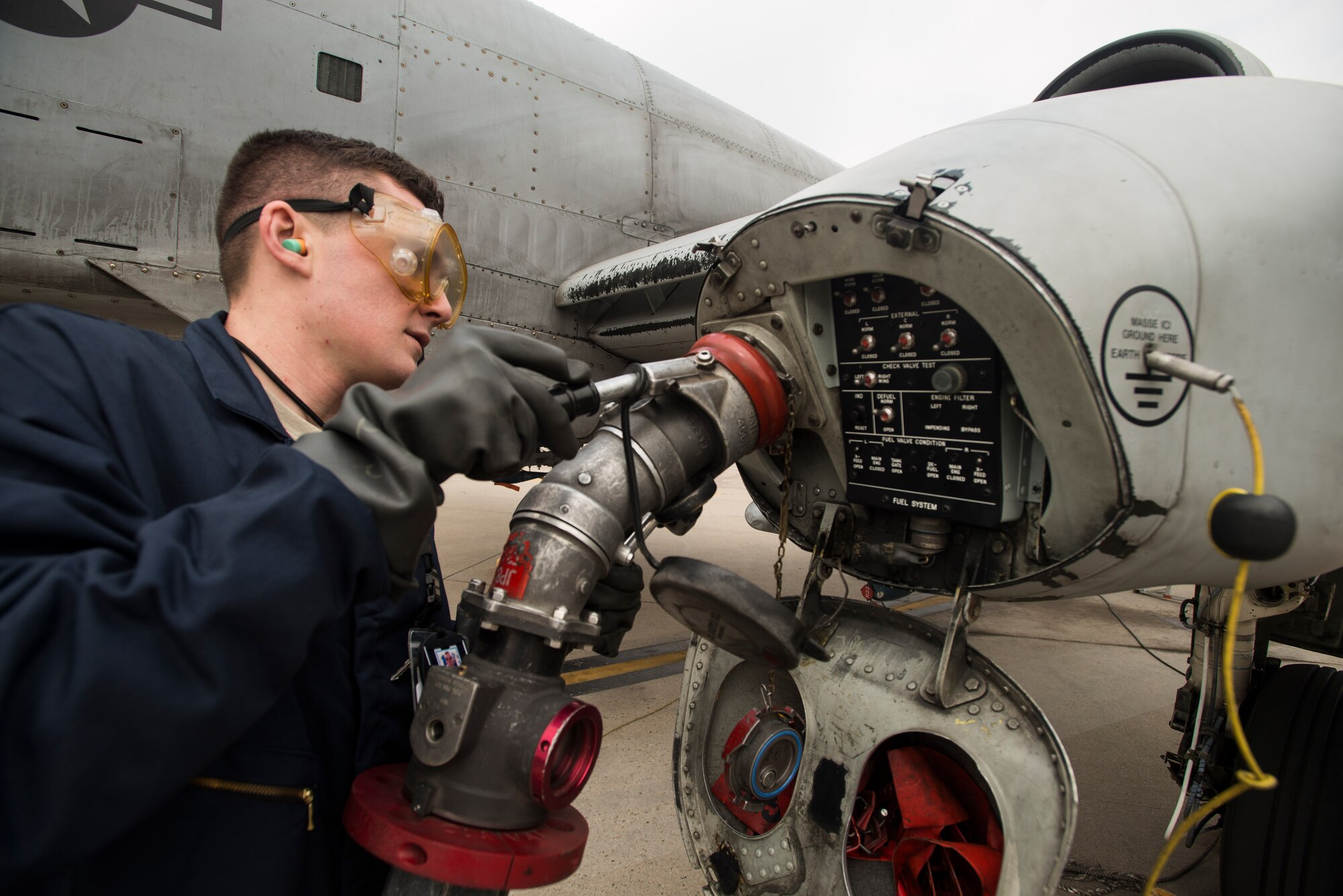 Airman 1st Class Kesten Accomando, a 25th Fighter Squadron crew chief, refuels an A-10 aircraft March 17, 2014, at Osan Air Base, Republic of Korea. The 25th FS is home to many A-10 aircraft with the mission of keeping stability in the Republic of Korea. (U.S. Air Force photo by Staff Sgt. Jake Barreiro)