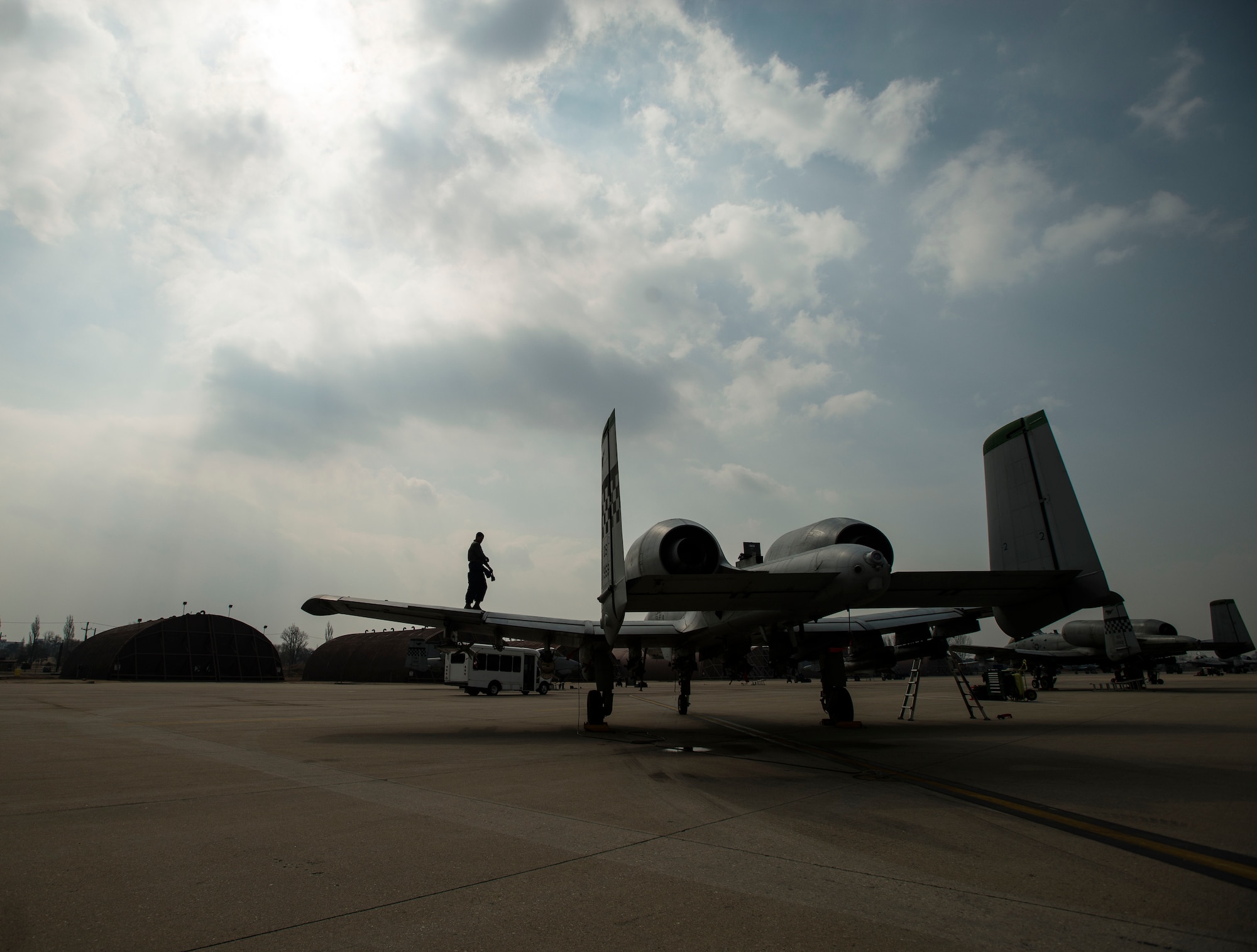 Senior Airman Kevin Lacy, a 25th Figher Squadron crew chief, works on the wing of a recently landed A-10 March 17, 2014, at Osan Air Base, Republic of Korea. Osan Air Base's primary mission is to provide stability to the Republic of Korea through day-to-night readiness. (U.S. Air Force photo by Staff Sgt. Jake Barreiro.)