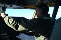 1st Lt. Ryan Snow, 203rd Air Refueling Squadron pilot, runs through checklists shortly after takeoff aboard a KC-135 Stratotanker near Joint Base Pearl Harbor-Hickam, Hawaii, March 14, 2014. Snow and his crew participated in a Warrior Day training exercise as part of Sentry Aloha, an air-to-air exercise that allowed participants to practice offensive and defensive wartime tactics. (U.S. Air Force photo/Staff Sgt. Alexander Martinez)
