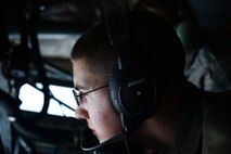 Airman 1st Class Scott Willard, 96th Air Refueling Squadron boom operator, guides a boom to connect to an aircraft during an in-air refueling aboard a KC-135 Stratotanker near Joint Base Pearl Harbor-Hickam, Hawaii, March 14, 2014. Willard and his crew participated in a Warrior Day training exercise as part of Sentry Aloha, an air-to-air exercise that allowed participants to practice offensive and defensive wartime tactics. (U.S. Air Force photo/Staff Sgt. Alexander Martinez)