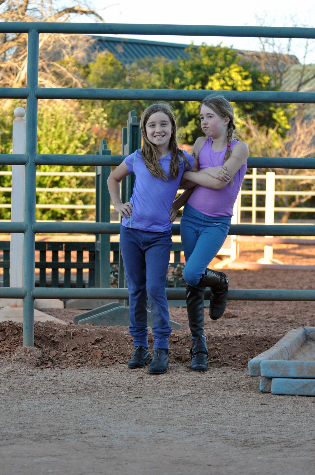 Lauren Pickett, left, and Gianna Banning pose for a picture in front of the riding arena at Ashbrook Farm in Tucson, Ariz., March 10, 2014. Lauren and Gianna have been riding for three and four years respectively, and both love the sport. Lauren is the daughter of Maj. Michael Picket, 354th Fighter Squadron A-10 pilot, and Gianna is the daughter of Lt. Col. Scott Banning, 47th Fighter Squadron A-10 pilot. (U.S. Air Force photo by Capt. Susan Harrington/Released)