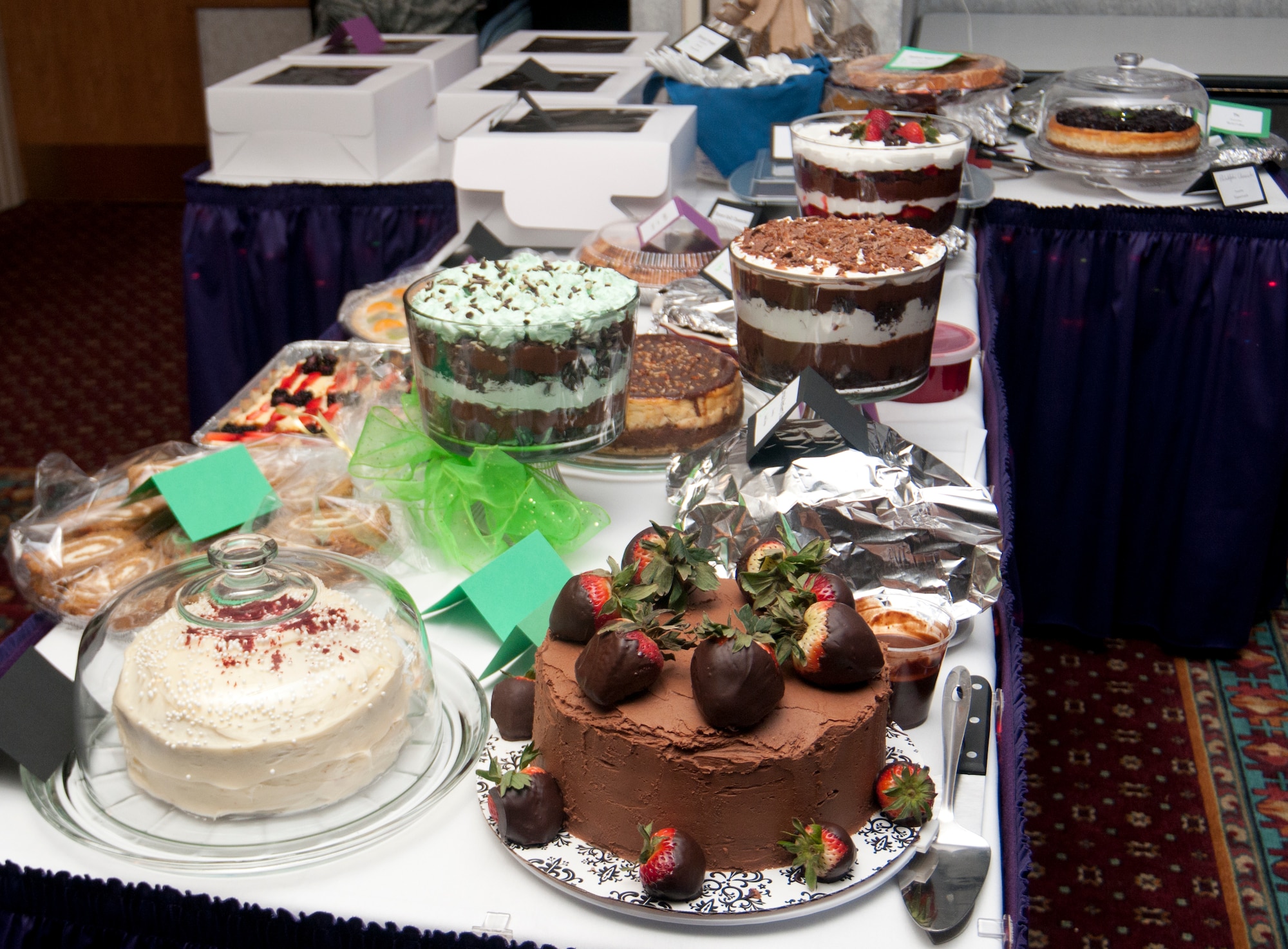 Desserts line a table in the Trail’s End Club during the 8th Annual Warren Spouses Club Basket Auction & Masquerade March 15, 2014. Attendees would later be able to bid on the desserts and share them with their tablemates. (U.S. Air Force photo by Airman 1st Class Jason Wiese)