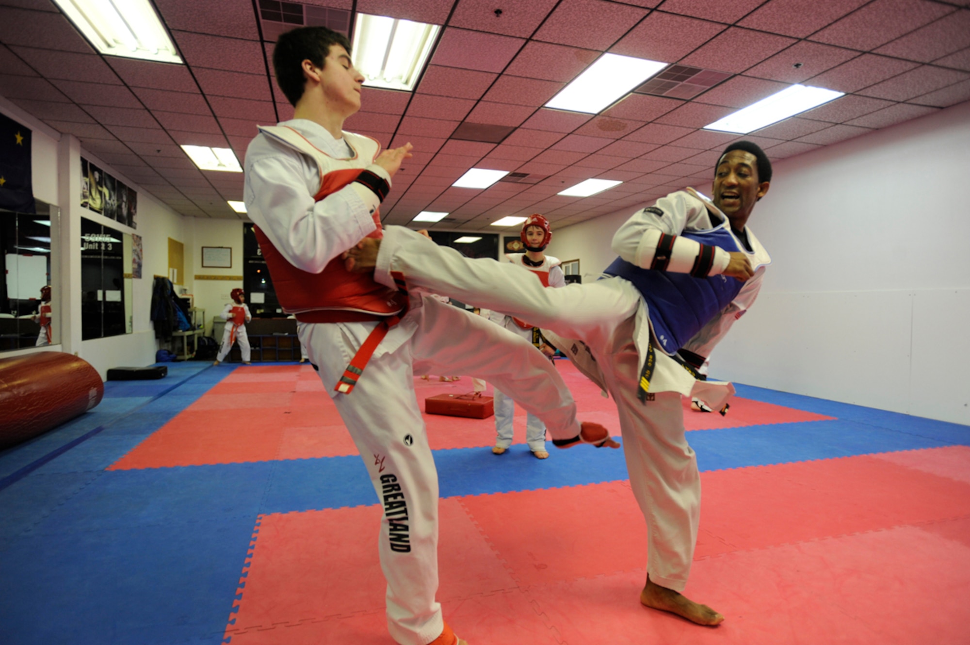 Quinton Beach kicks Micah Foreman, 16, back during practice at a Taekwondo Elite USA class in Anchorage March 7, 2014. Beach, a technical sergeant out of Joint Base Elmendorf-Richardson, Alaska, is a third-degree black belt in tang soo do and a first-degree black belt in taekwondo. (U.S. Air Force photo/Staff Sgt. Robert Barnett)