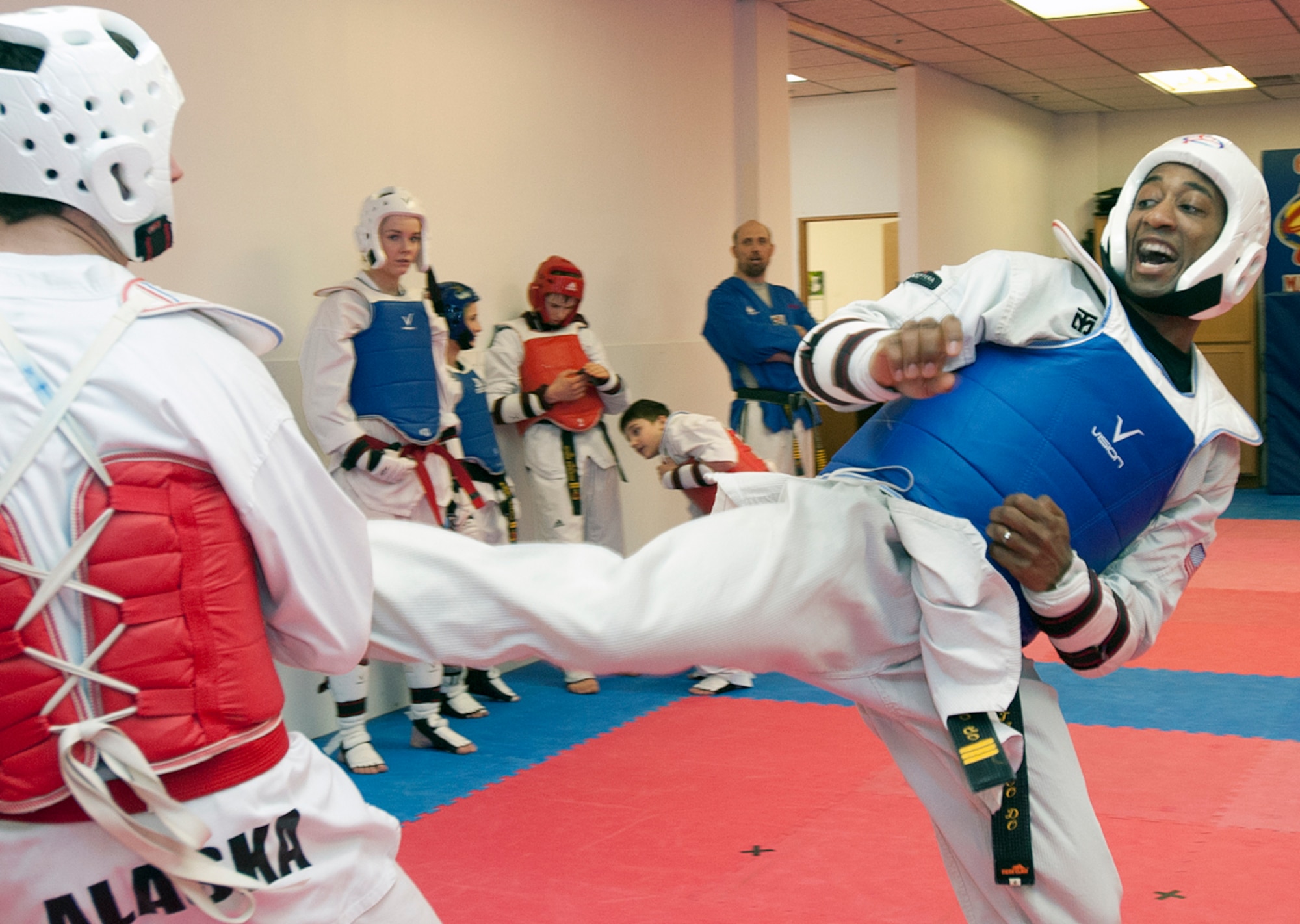 Quinton Beach kicks Micah Foreman, 16, back during practice at a Taekwondo Elite USA class in Anchorage March 7, 2014. Beach, a technical sergeant out of Joint Base Elmendorf-Richardson, Alaska, is a third-degree black belt in tang soo do and a first-degree black belt in taekwondo. (U.S. Air Force photo/Staff Sgt. Robert Barnett)