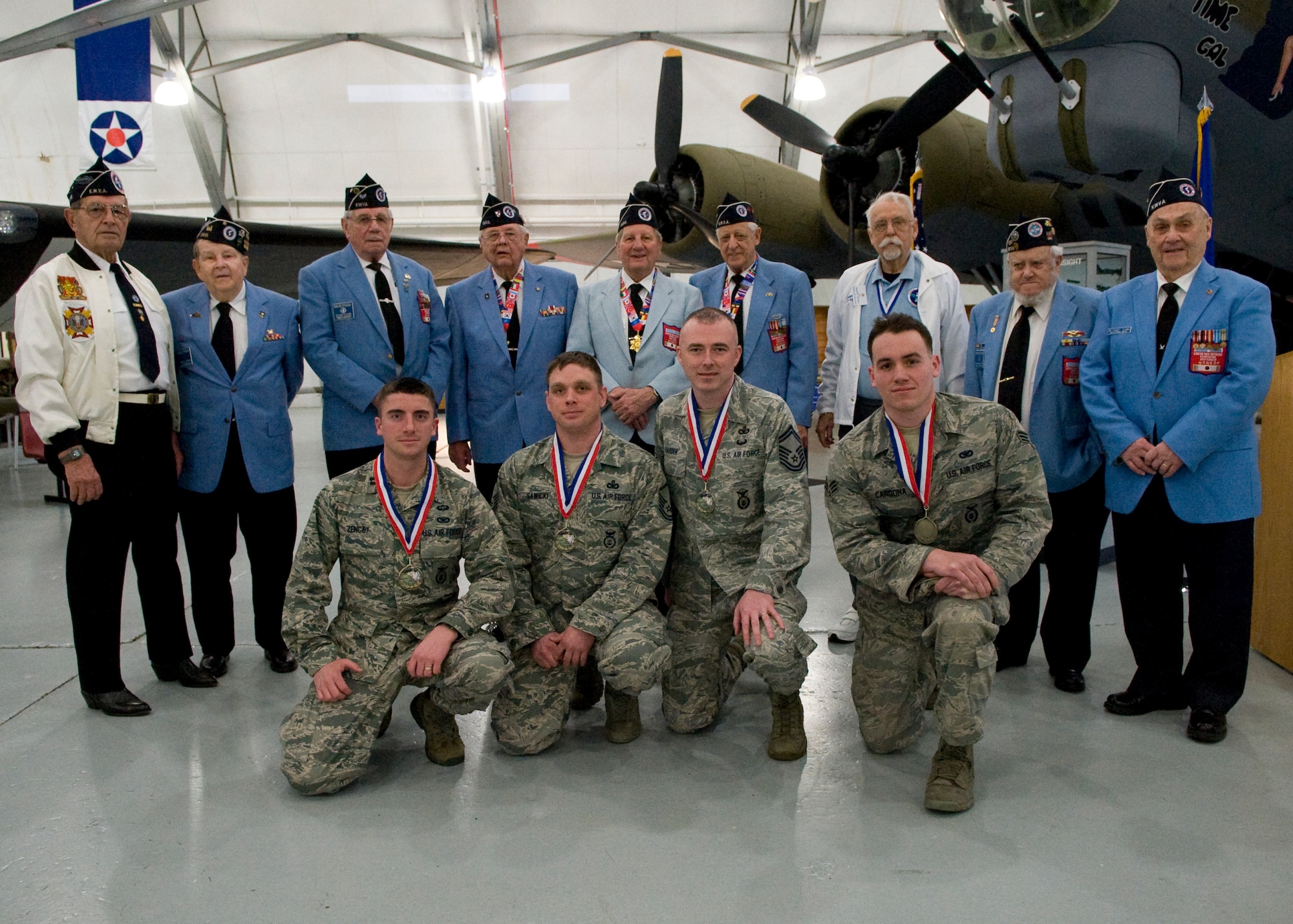 Team Hanscom Defenders from the 66th  Security Forces Squadron, Hanscom Air Force Base, Mass. pose with nine members of the Delaware Chapter of the Korean War Veterans Association March 15, 2014, inside the Air Mobility Command Museum on Dover Air Force Base, Del. Team Hanscom won the team competition in the 15th Annual 436th Security Forces Ruck March. (U.S. Air Force photo/Airman 1st Class Zachary Cacicia)