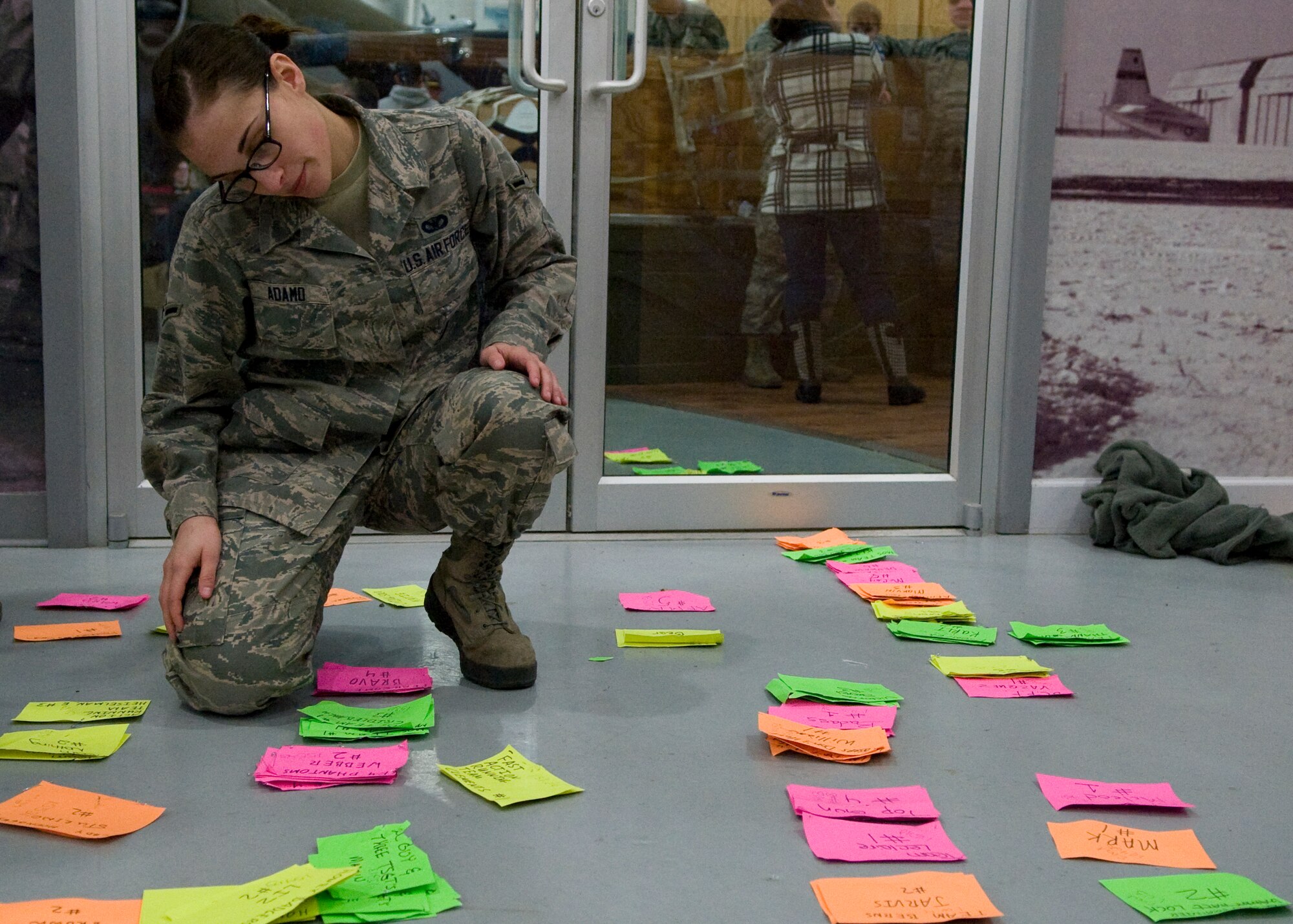 Airman Brittany Adamo, 436th Security Forces Squadron, sorts through runner time cards March 15, 2014, after the completion of the 15th Annual 436th Security Forces Ruck March at the Air Mobility Command Museum on Dover Air Force Base, Del. These time cards were used to keep track of the each runners race completion time. (U.S. Air Force photo/Airman 1st Class Zachary Cacicia)