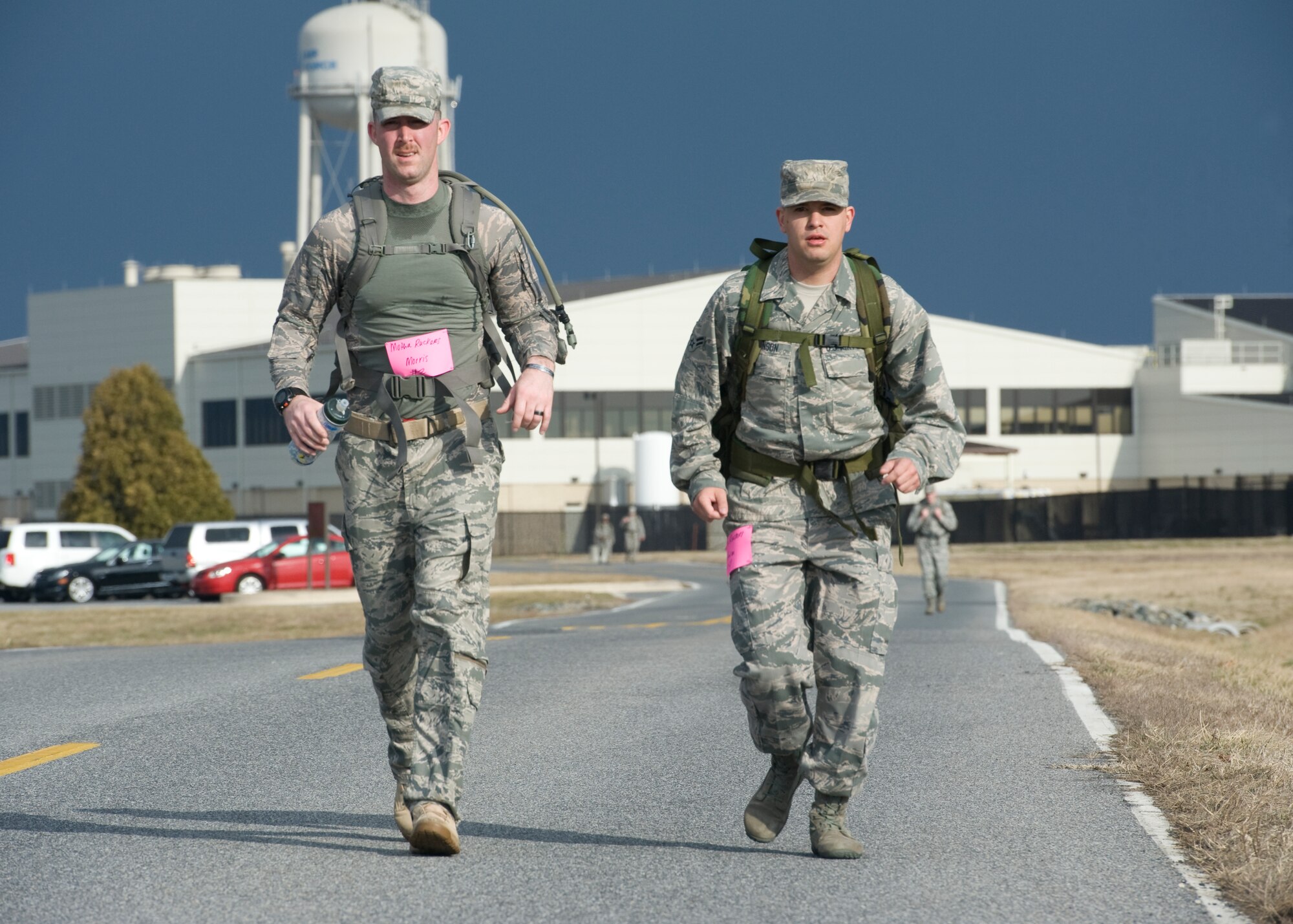 Staff Sgt. Clayton Morris, 436th Operations Support Squadron aircrew flight equipment assistant non-commissioned officer-in-charge, left, and Airman 1st Class William Johnson, 436th Airlift Wing Public Affairs photojournalist, run down Perimeter Road March 15, 2014, during the 15th Annual Security Forces Ruck March at Dover Air Force Base, Del. Teams of four runners each competed to finish the 6.2 miles in the fastest collective time. (U.S. Air Force photo/Airman 1st Class Zachary Cacicia)