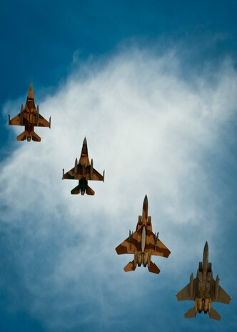 Two U.S. Air Force F-16C Fighting Falcons assigned to the 64th Aggressor Squadron, and two U.S. Air Force F-15C Eagles assigned to the 65th Aggressor Squadron, fly in formation overhead the Nellis Air Force Base, Nev. air field during Red Flag 14-2, March 13, 2014. Gen. Robert Dixon, then commander of Tactical Air Command, established Red Flag in 1975 to better prepare Airmen for combat missions. (U.S. Air Force photo by Airman 1st Class Thomas Spangler)  