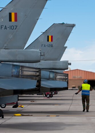 A Belgian air force maintainer conducts a pre-flight inspection on a Belgian air force F-16 Fighting Falcon prior to a training mission during Red Flag 14-2, March 13, 2014, at Nellis Air Force Base, Nev. More than 440,000 service members have participated in Red Flag since 1975, including more than 145,000 aircrew members flying more than 385,000 sorties and logging more than 660,000 flight hours. Red Flag training missions increase air and ground crews in operational readiness and combat effectiveness. (U.S. Air Force photo by Airman 1st Class Thomas Spangler)