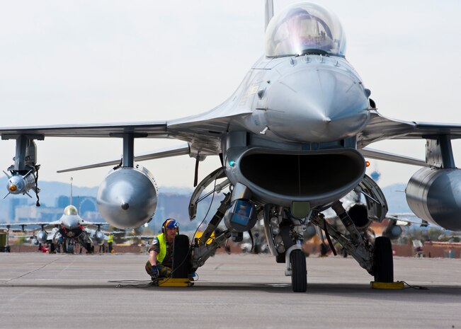 A Belgian air force maintainer prepares a Belgian air force F-16 Fighting Falcon for a training mission during Red Flag 14-2, March 13, 2014, at Nellis Air Force Base, Nev. Red Flag provides military members an opportunity to experience realistic combat scenarios to prepare and train for future conflicts. (U.S. Air Force photo by Airman 1st Class Thomas Spangler)