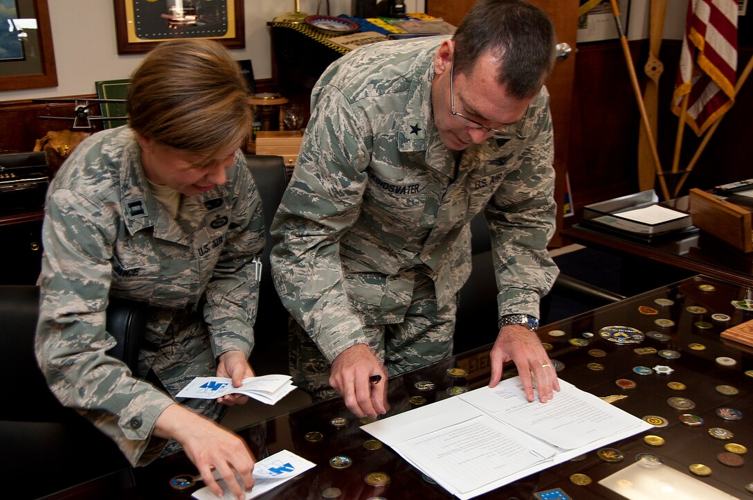 Brig. Gen. Scott Kindsvater, 82nd Training Wing Commander, and Capt. Yonca Nice, 82nd Security Forces Squadron operations officer, prepare to sign a pledge for the Air Force Assistance Fund in the 82nd TRW office March 18, 2014.  AFAF is one of only two official fundraisers. (U.S. Air Force photo/Airman 1st Class Robert L. McIlrath)