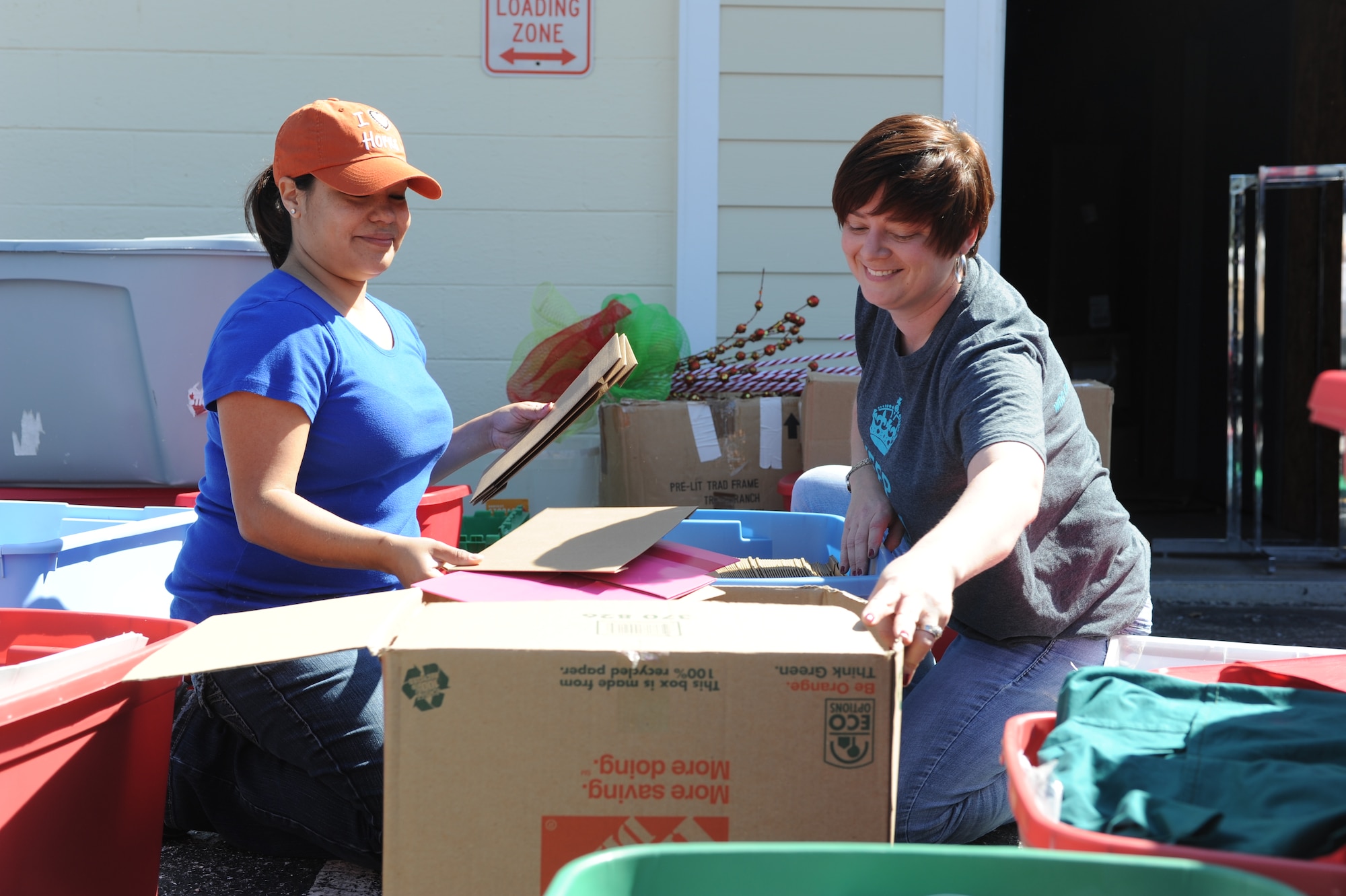 Tech. Sgt. Angelica Stevenson and Tech. Sgt. Jessica Carter, 1st Special Operations Contracting Squadron contract specialists, label boxes at the Shelter House in Fort Walton Beach, Fla., March 1, 2014. The Shelter House is a non-profit center that helps victims of domestic and sexual violence. (U.S. Air Force photo/Senior Airman Hayden Hyatt)
