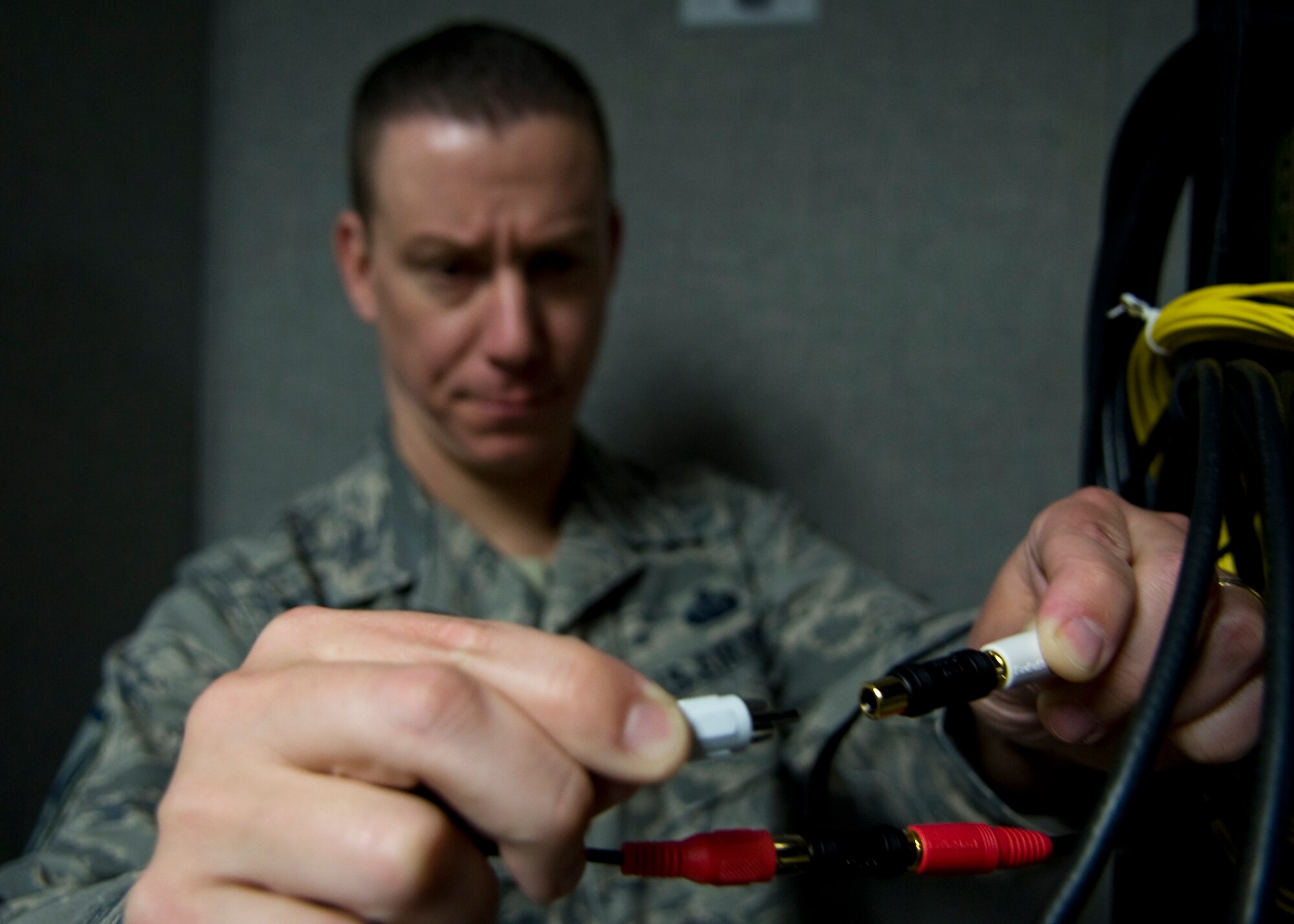 Master Sgt. David White, 436th Communications Squadron plans and implementations flight superintendent, connects two audio wires together March 17, 2014, at Dover Air Force Base, Del. White was the 436th CS operations flight superintendent before becoming the 436th CS plans and implementations flight superintendent. (U.S. Air Force photo/Airman 1st Class Zachary Cacicia)