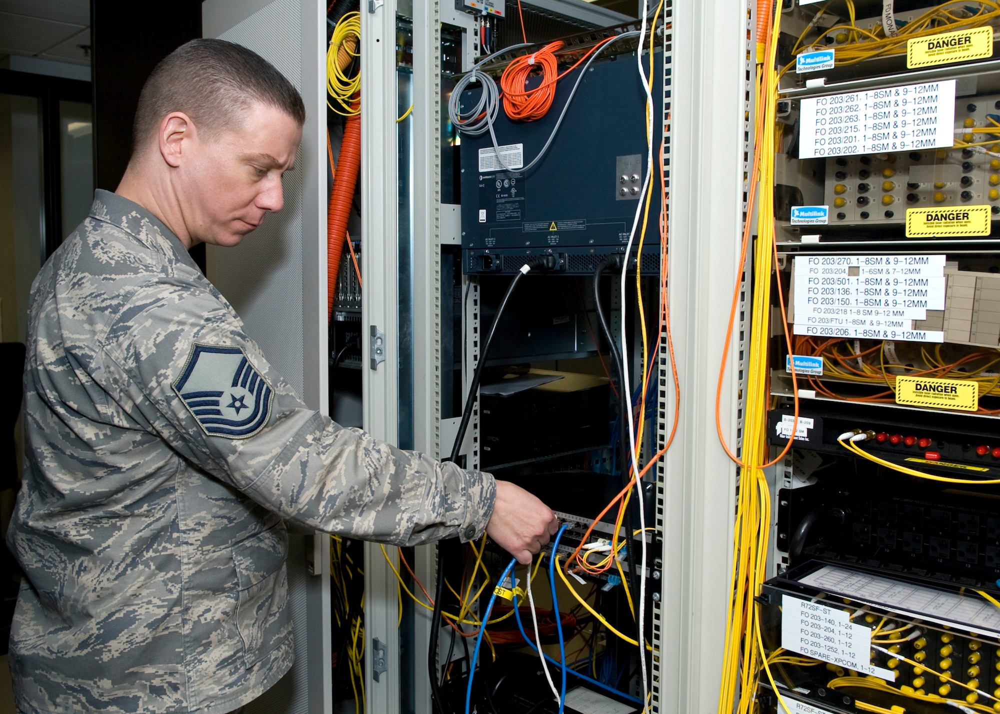 Master Sgt. David White, 436th Communications Squadron plans and implementations flight superintendent, inspects wiring on computer server racks March 17, 2014, at Dover Air Force Base, Del. White was one of 1,183 Airmen around the Air Force eligible to win the 2013 Air Force Outstanding Cyberspace Systems Senior Non-Commissioned Officer Award. (U.S. Air Force photo/Airman 1st Class Zachary Cacicia)