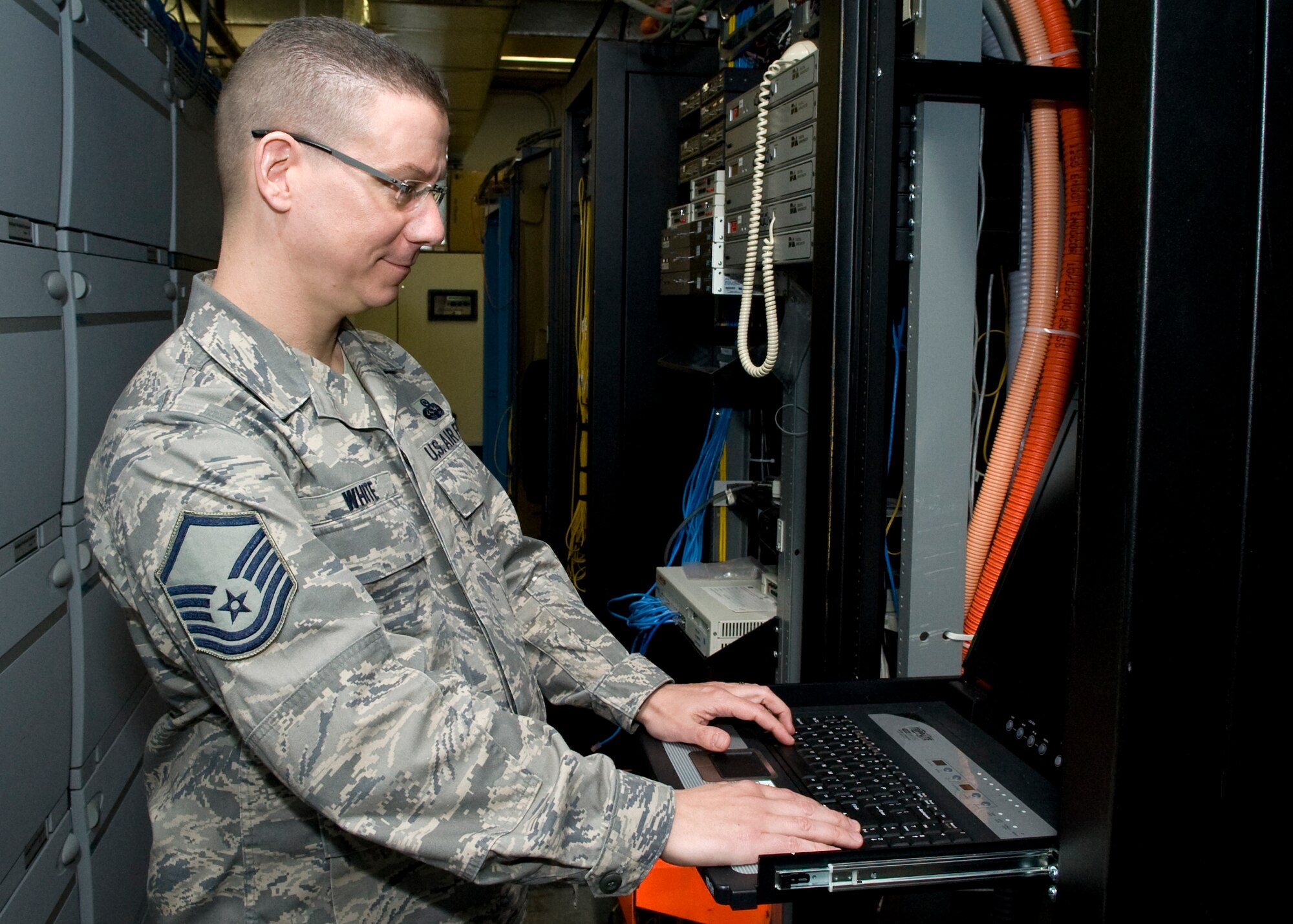 Master Sgt. David White, 436th Communications Squadron plans and implementations flight superintendent, logs into a telephone switch room computer March 13, 2014, at Dover Air Force Base, Del. White recently arrived at Dover AFB after a tour at Ramstein Air Base, Germany. (U.S. Air Force photo/Airman 1st Class Zachary Cacicia) 