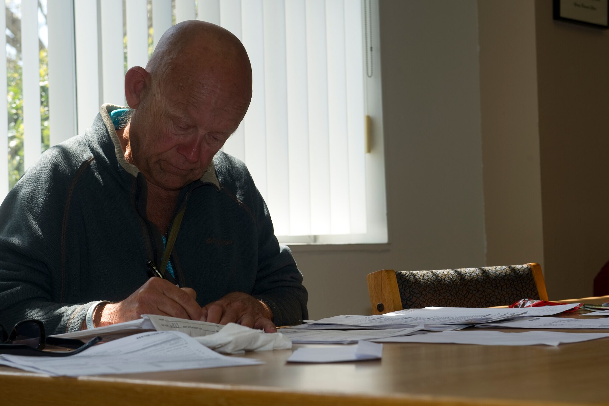 Retired Air Force Maj. Ward Anderson fills out his tax paperwork inside the base library at Hurlburt Field, Fla., March 18, 2014. Anderson retired as a pilot out of a New York Air Force base. (U.S. Air Force photo/Senior Airman Naomi Griego)    