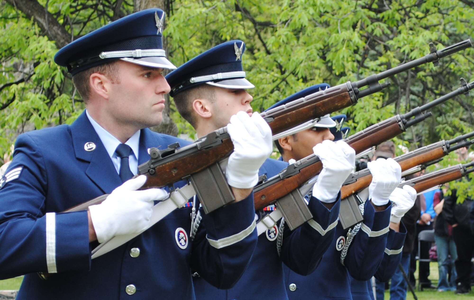 (Left) Senior Airman Jeffrey M. Lowder and other members of the Grand Forks Air Force Base Honor Guard perform a firing squad salute during a Memorial Day ceremony May 24, 2013, at Memorial Park Cemetery in Grand Forks, N.D. Lowder was named the 2013 U.S. Air Force Expeditionary Center Honor Guard Member of the Year. (U.S. Air Force photo/Staff Sgt. Luis Loza Gutierrez) 
