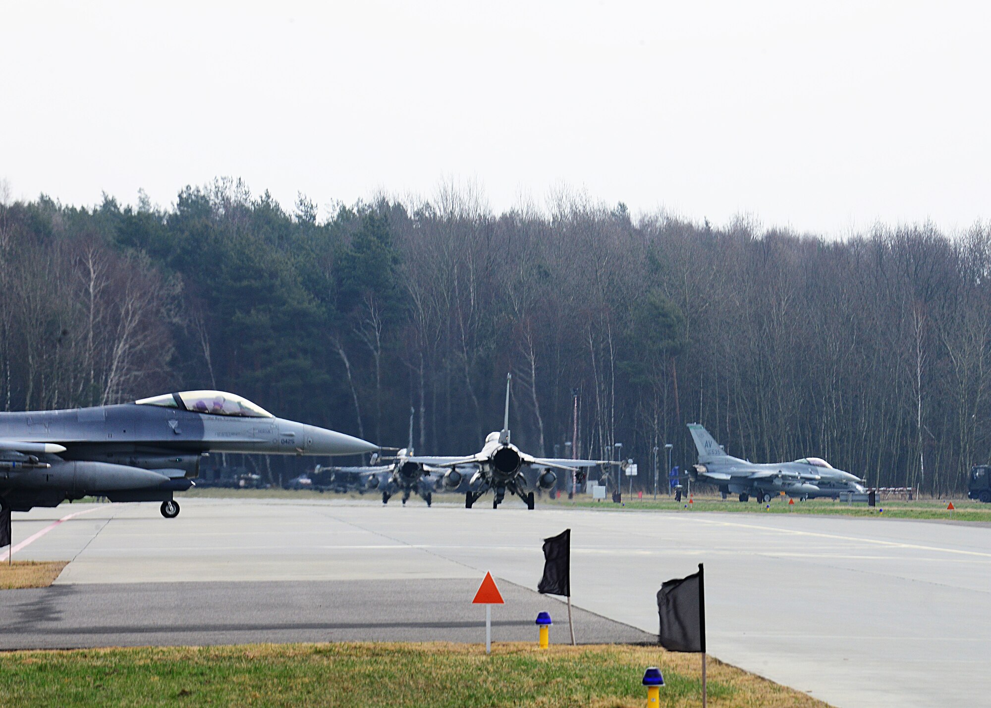 Four 555th Fighter Squadron F-16 Fighting Falcons taxi down the runway before a training mission, March 18, 2014, at Lask Air Base, Poland. The aerial training exercises a pilot’s ability to operate across a range of military operations with precise full-spectrum capabilities. (U.S. Air Force photo/Airman 1st Class Ryan Conroy)