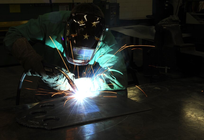 Staff Sgt. Neil Oltmer, 22nd Civil Engineer Squadron structural journeyman, uses metallic inert gas welding to build a mounting plate, March 18, 2014, at McConnell Air Force Base, Kan. The plate will be used as a part of a flightline gate to allow fire trucks to exit while responding to emergencies. (U.S. Air Force photo/Airman 1st Class David Bernal Del Agua)
