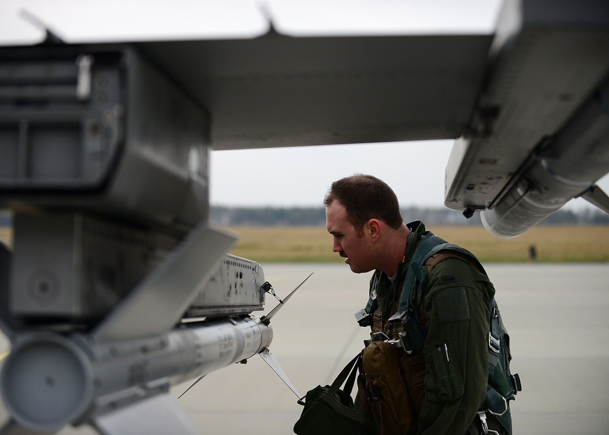 First Lieutenant Matthew Alexander, 555th Fighter Squadron pilot, performs a preflight inspection before a training mission, March 18, 2014, at Lask Air Base, Poland. The aerial training exercises a pilot’s ability to operate across a range of military operations with precise full-spectrum capabilities.  (U.S. Air Force photo/Airman 1st Class Ryan Conroy) 