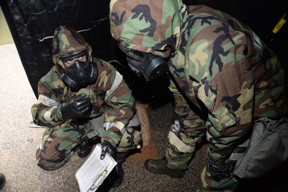 [Left to right] U.S. Air Force Senior Airman Jeremy Cole, 20th Medical Group mental health specialist, briefs Senior Airman Alan Manuszak, 20th Communications Squadron radio frequency specialist, on how to perform a post-attack reconnaissance sweep, Shaw Air Force Base, S.C., March 18, 2014. Cole and Manuszak participated in chemical, biological, radioactive and nuclear training that refreshed their knowledge of alarm signals, mission oriented protective posture levels, and how to perform a PAR sweep. (U.S. Air Force photo by Airman 1st Class Michael A. Cossaboom/Released) 