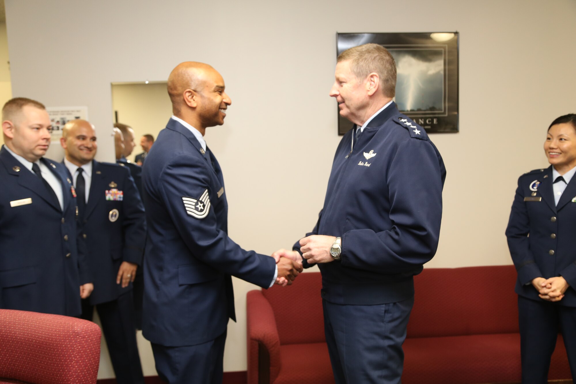 Gen. Robin Rand, commander of Air Education and Training Command, presents a coin to Tech. Sgt. David Bell, 341st Recruiting Squadron E-Flight recruiter, Jan. 30. Rand visited Airmen assigned to the 369th Recruiting Group at the recruiting schoolhouse on Joint Base San Antonio-Lackland, Texas. (U.S. Air Force photo)