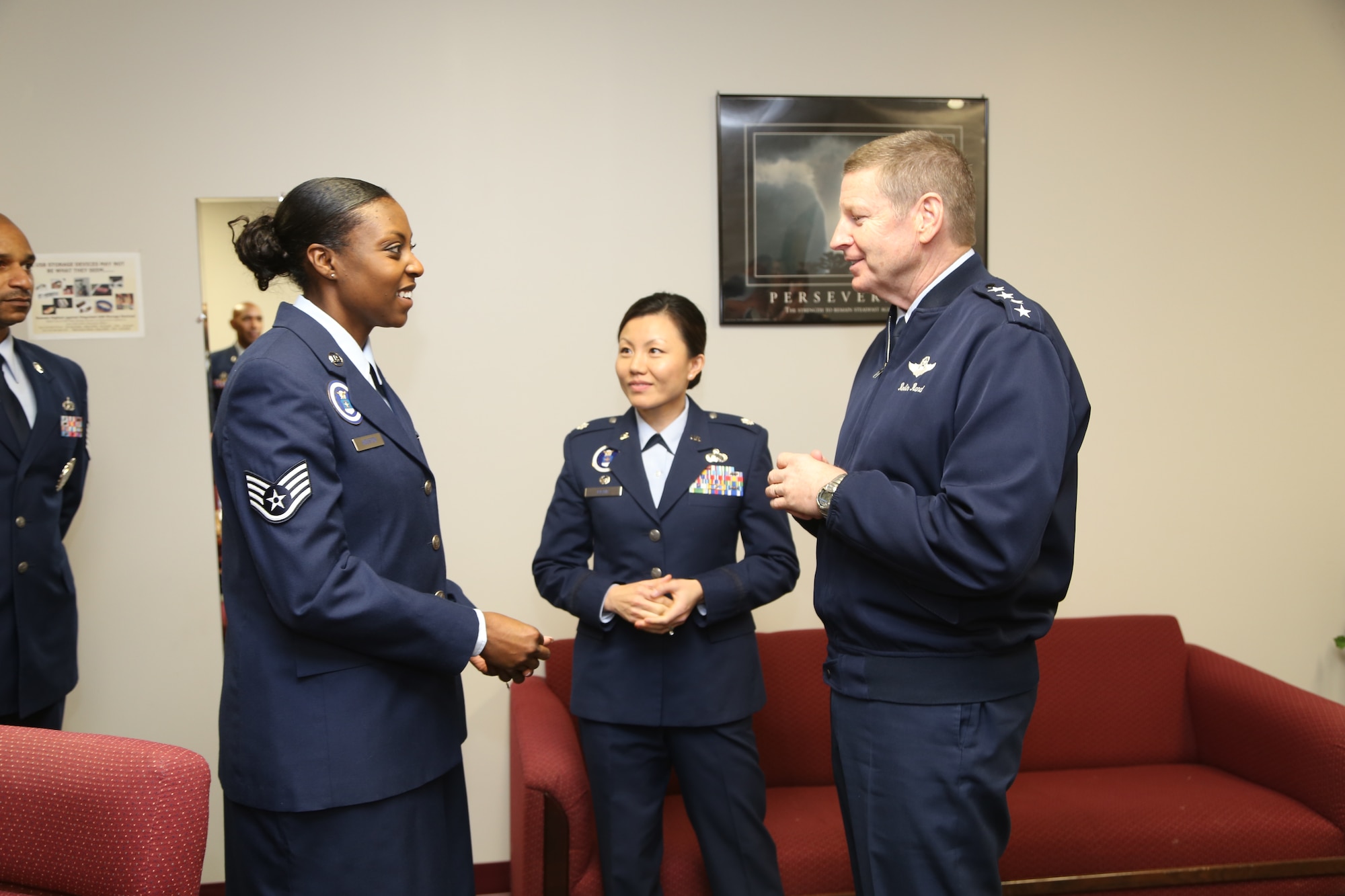 Gen. Robin Rand, commander of Air Education and Training Command, presents a coin to Staff Sgt. Lakeydra Houston, 341st Recruiting Squadron H-Flight recruiter, Jan. 30, while Lt. Col. Angie Blair, 341st RCS commander, looks on. Rand visited Airmen assigned to the 369th Recruiting Group at the recruiting schoolhouse on Joint Base San Antonio-Lackland, Texas. (U.S. Air Force photo)