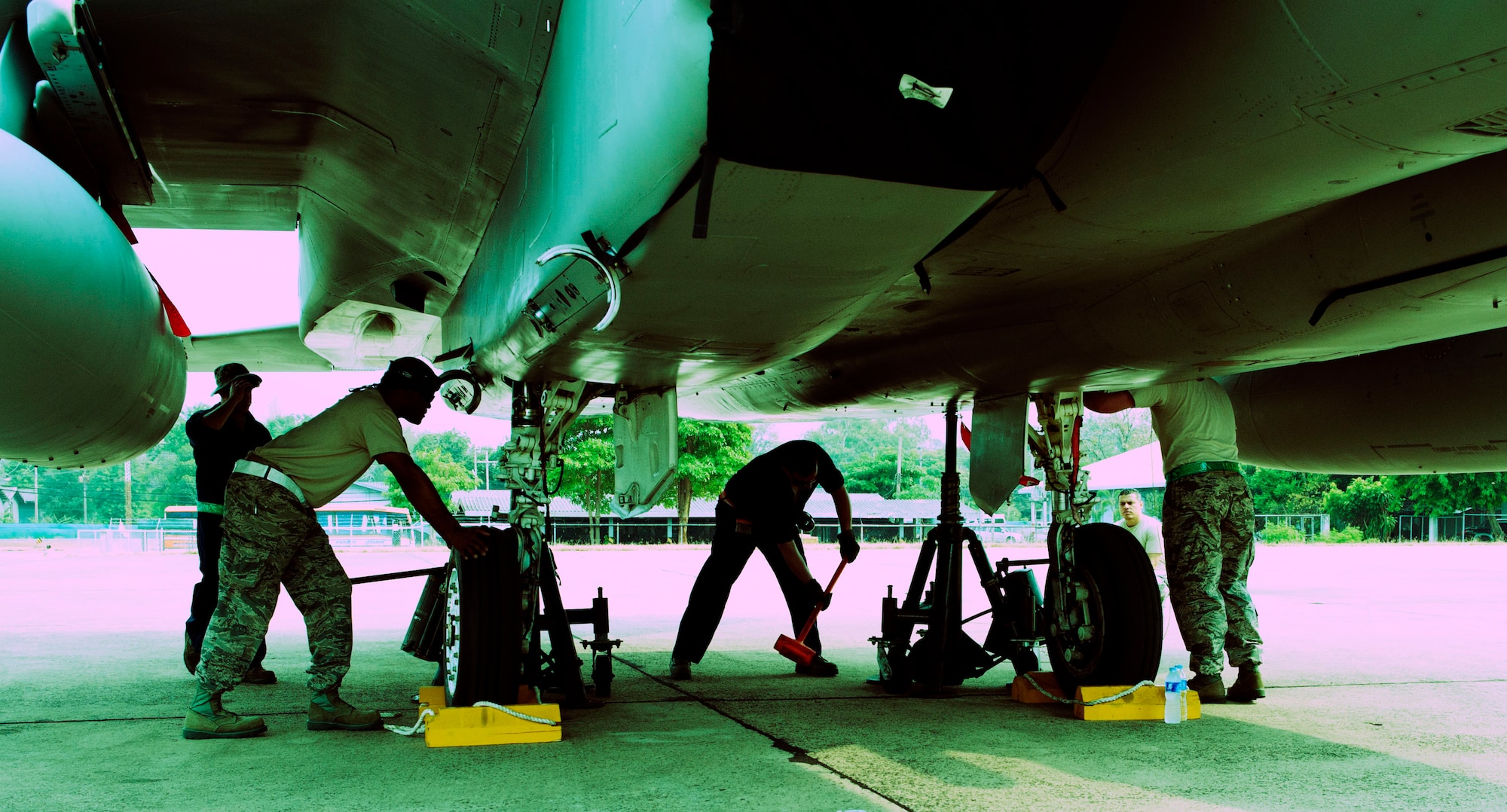 Maintainers from the 159th Fighter Wing, Louisiana Air National Guard, raise an F-15 Eagle on jacks to inspect a landing gear issue. Cope Tiger 2014 is an annual, multilateral aerial exercise in Thailand to improve combat readiness, interoperability and build relations among Thailand, Singapore and the United States. (U.S. Air Force photo by 2Lt. Michael Harrington/Released)