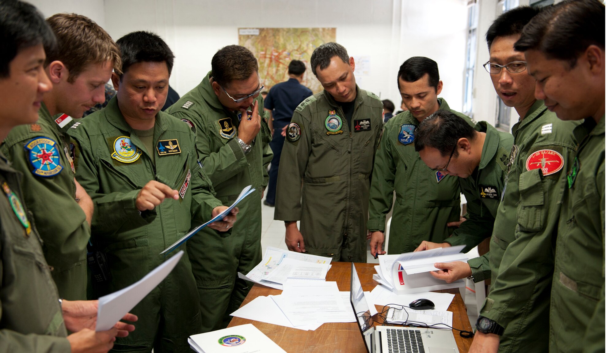 U.S., Thailand and Singapore Air Force pilots discuss mission plans before beginning flying exercises for Multilateral Exercise Cope Tiger in Korat, Thailand. Cope Tiger 2014 is an annual, multilateral aerial exercise to improve combat readiness, interoperability and build relations among the three nations. (U.S. Air Force photo by 2Lt. Michael Harrington/Released)