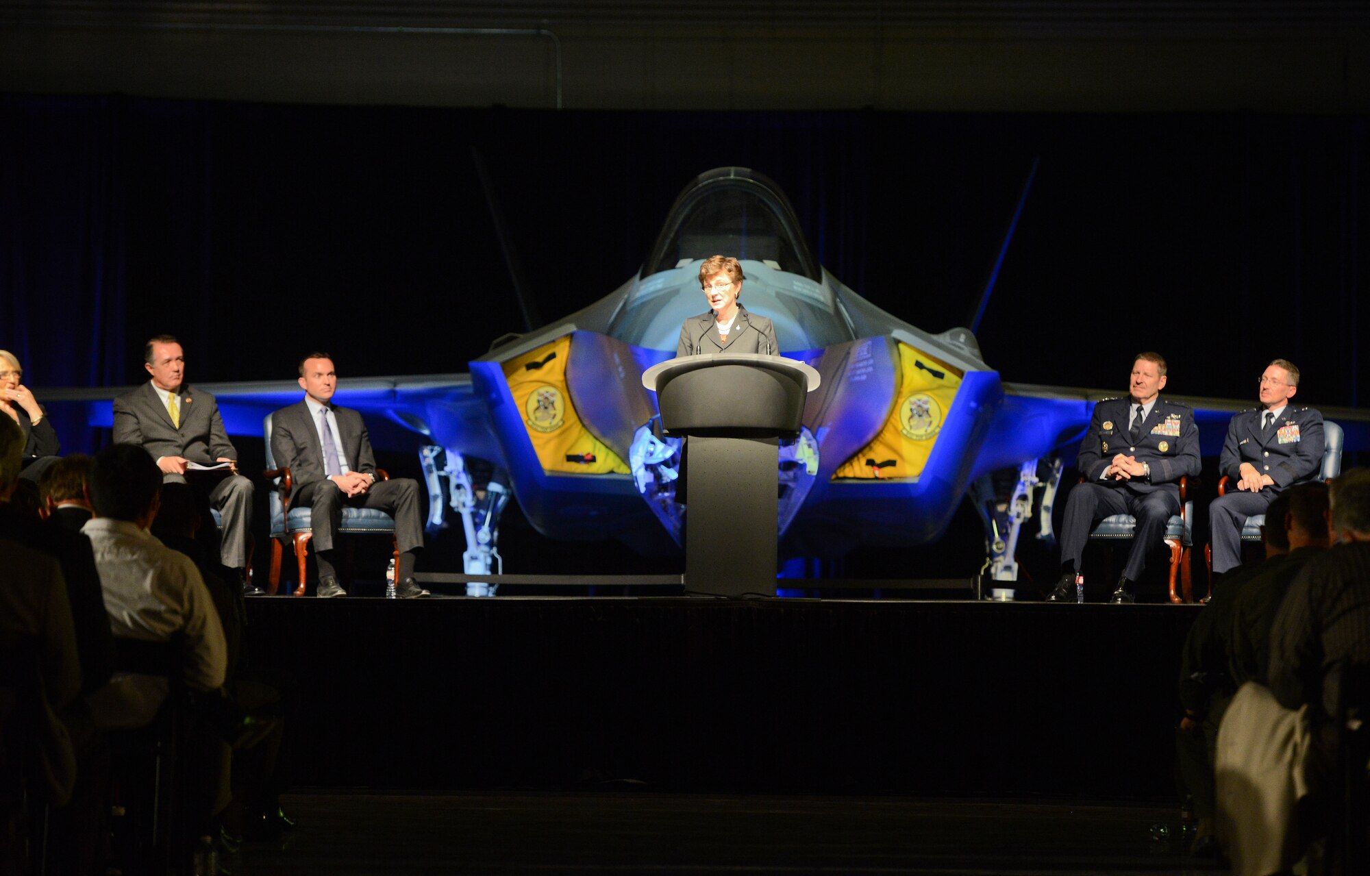 Lorraine Martin, vice president and general manager of the F-35 program for Lockheed Martin, addresses an audience of approximately 500 community leaders, elected officials, representatives from partner nation air forces and Luke Airmen during an unveiling ceremony on March 14 at Luke Air Force Base for the 56th Fighter Wing’s first F-35 Lightning II fighter jet. Martin was joined on stage by Arizona Governor Jan Brewer, Congressman Trent Franks, Undersecretary of the Air Force Eric Fanning, Brig. Gen. Mike Rothstein, 56th Fighter Wing commander, and Gen. Robin Rand, commander of Air Education and Training command. (U.S. Air Force photo by Senior Airman Devante Williams)